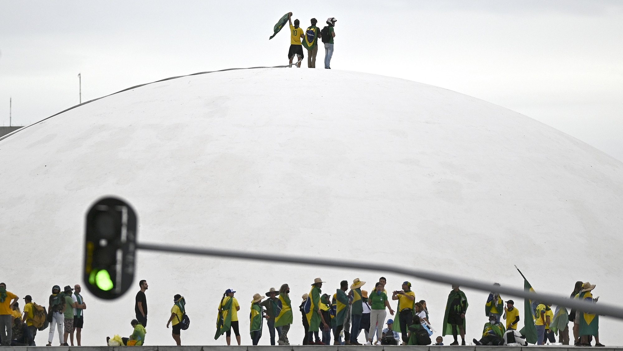 epa10997277 Supporters of Brazil&#039;s former president Jair Bolsonaro walk on the dome of the National Congress during a protest in Brasilia, Brazil, 08 January 2023. Hundreds of Bolsonaro supporters stormed the headquarters of the National Congress, the Supreme Court, and the Planalto Palace, the seat of the Presidency of the Republic, in a demonstration calling for a military intervention to overthrow President Luiz Inacio Lula da Silva.  EPA/ANDRE BORGES