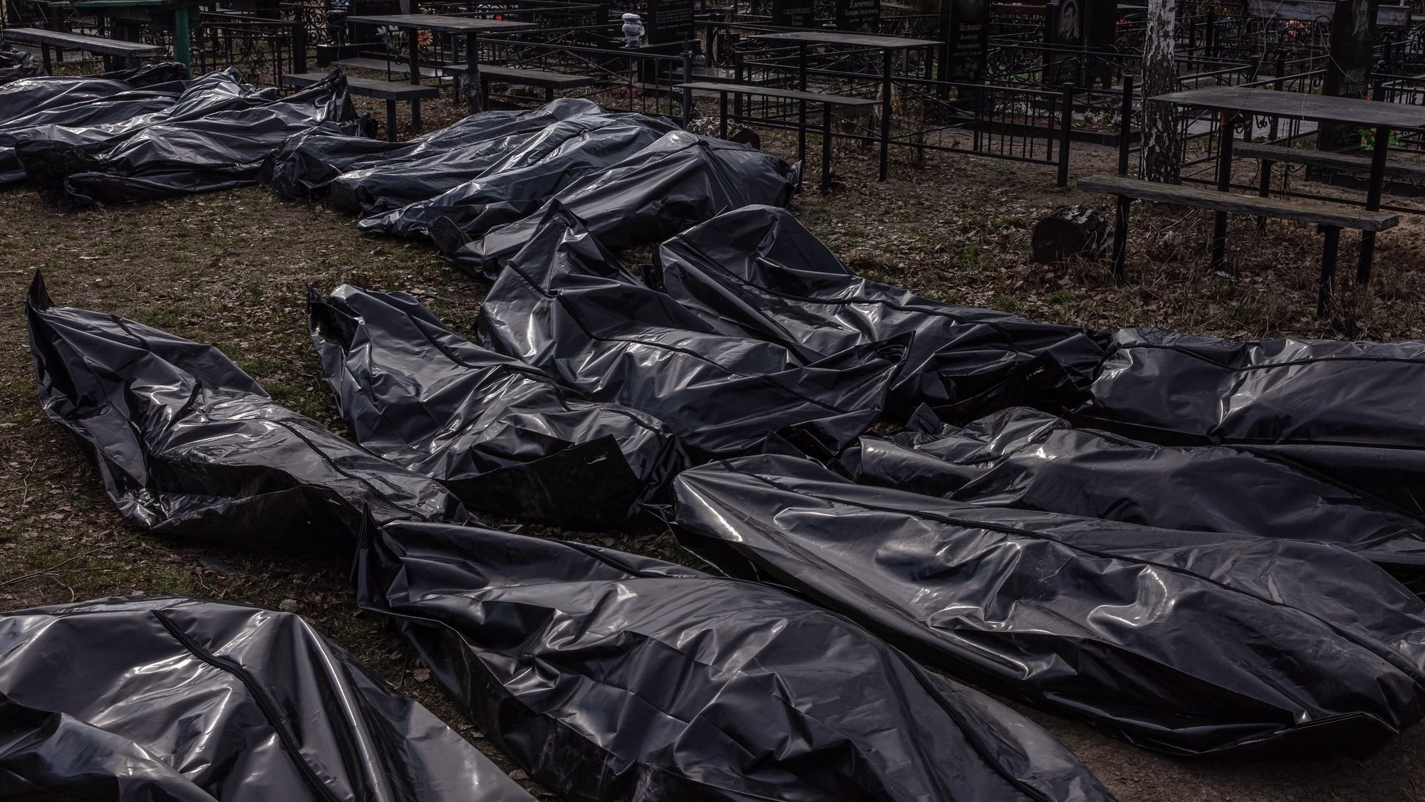 epaselect epa09877034 Bodies of killed people, which were brought to the cemetery, lay on the ground in body bags, in Bucha, northwest of Kyiv, Ukraine, 07 April 2022. Hundreds of tortured and killed civilians have been found in Bucha and other parts of the Kyiv region after the Russian army retreated from those areas. The growing evidence shows that the Russian forces are believed to be behind the atrocities when they were controlling the areas. Russian troops entered Ukraine on 24 February resulting in fighting and destruction in the country and triggering a series of severe economic sanctions on Russia by Western countries.  EPA/ROMAN PILIPEY