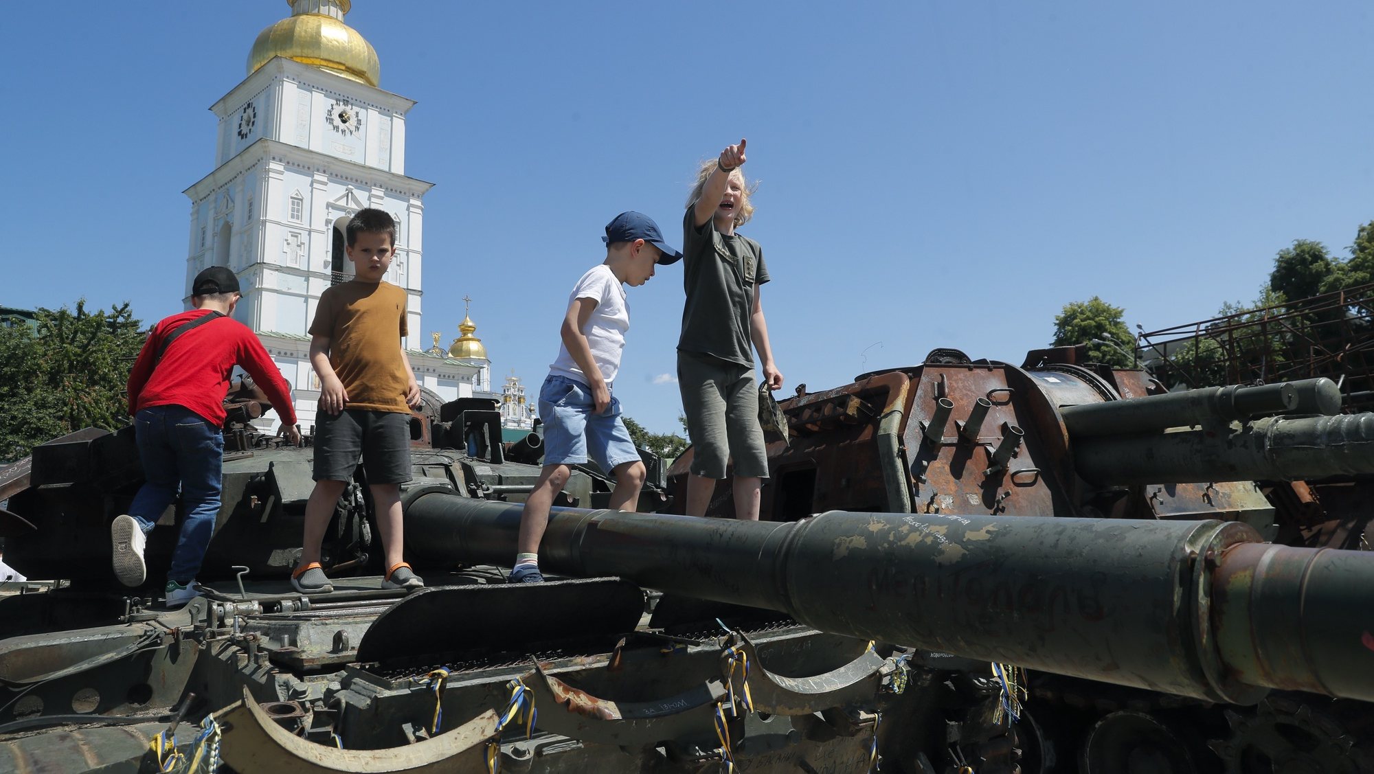 epa10672369 Children play on the damaged Russian military machinery displayed during an event to support children, near St. Mykhailivsky Cathedral in Kyiv, Ukraine, 04 June 2023 amid the Russian invasion. Ukrainians mark the &#039;Day of Remembrance of Children&#039; who died as a result of the armed aggression of Russia against Ukraine. At least 485 Ukrainian children were killed and more than one thousand were injured. In addition, almost 20,000 Ukrainian children were deported to the territory of the Russian Federation in the period from 24 February 2022, according to Kyiv City Military Administration. The event was founded by the Resolution of the Verkhovna Rada of Ukraine (Parliament) in 2021, coinciding with the UN’s International Day of Innocent Children Victims of Aggression, annually on June 04.  EPA/SERGEY DOLZHENKO