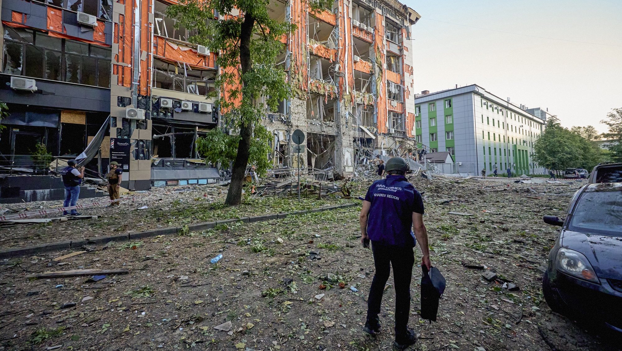 epa11370064 A war crimes prosecutor works at the site of shelling of a residential area in Kharkiv,  Ukraine, 25 May 2024 amid the Russian invasion. Kharkiv has been under massive rocket and glide-bomb attack during all day on May 25. At least 6 people died, 16 people are currently missing, and 33 were wounded in the glide-bombs attack on a hypermarket in Kharkiv today. Also, 18 people bounded in result of residential area shelling according to the report of the head of the Kharkiv Military Administration Oleg Synegubov. Russian troops entered Ukrainian territory on 24 February 2022, starting a conflict that has provoked destruction and a humanitarian crisis.  EPA/SERGEY KOZLOV 53533