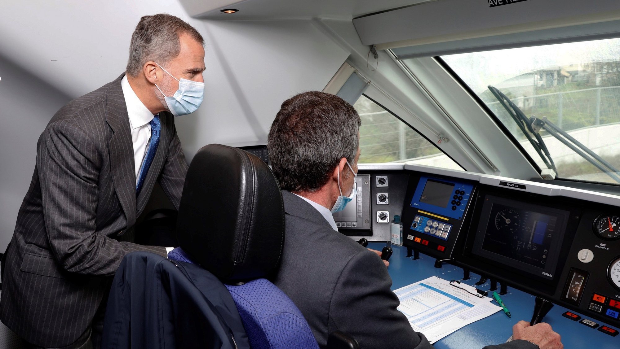 epa09651683 A handout picture provided by Spanish Royal House that shows King Felipe VI (L) at the cabin during the opening trip of high speed train AVE from Madrid to Ourense, in Madrid, Spain, 20 December 2021.  EPA/FRANCISCO GOMEZ / SPANISH ROYAL HOUSE / HANDOUT  HANDOUT EDITORIAL USE ONLY/NO SALES