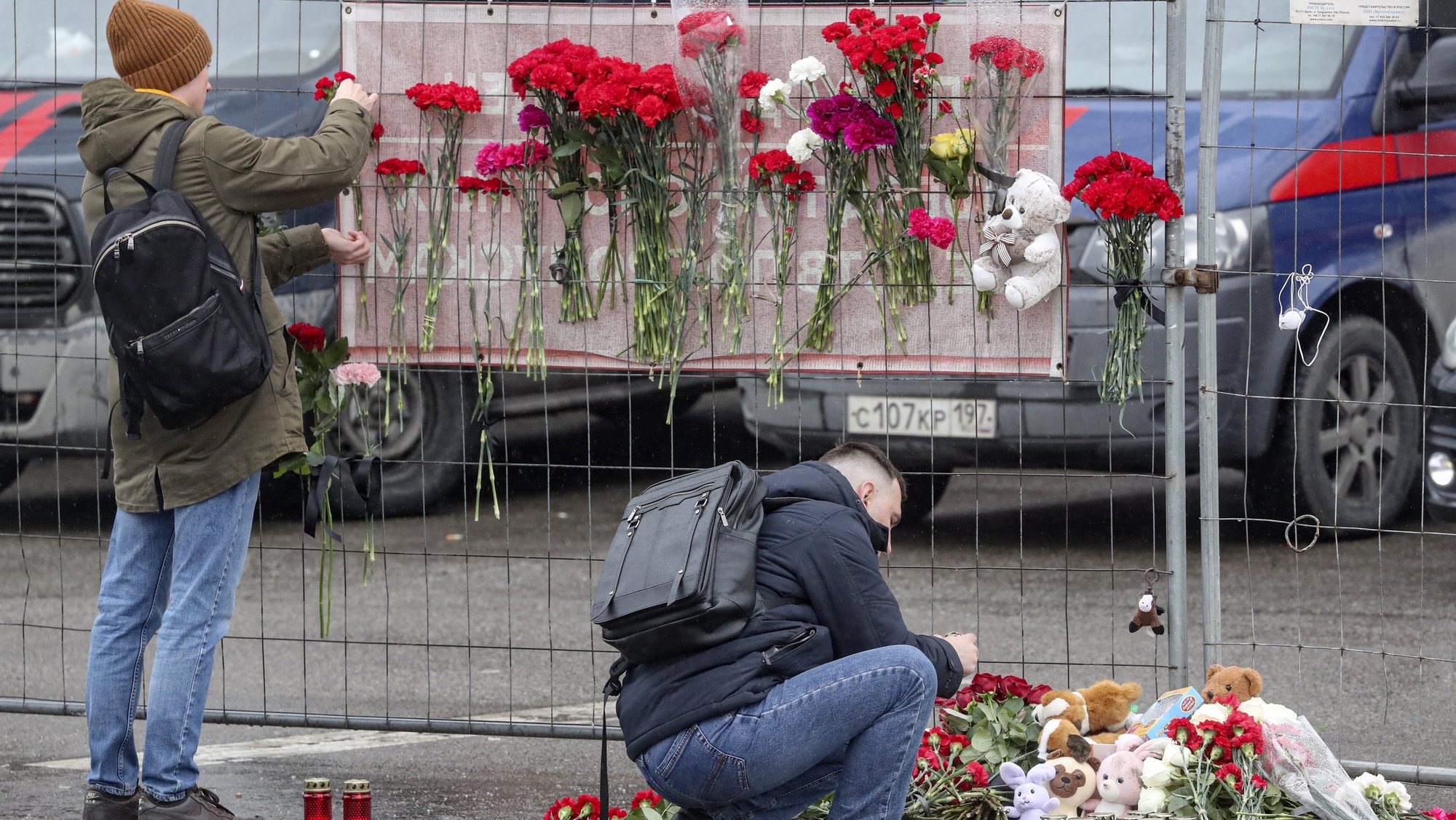 epa11238293 People bring flowers to the burned Crocus City Hall concert venue following a terrorist attack in Krasnogorsk, outside Moscow, Russia, 23 March 2024.  On 22 March evening, a group of up to five gunmen attacked the Crocus City Hall in the Moscow region, Russian emergency services said. 93 people were killed and more than 100 others were hospitalized, the Investigative Committee confirmed. The head of the Russian FSB, Alexander Bortnikov, reported to Russian President Vladimir Putin on 23 March on the arrest of 11 people, including all four terrorists directly involved in the terrorist attack.  EPA/MAXIM SHIPENKOV