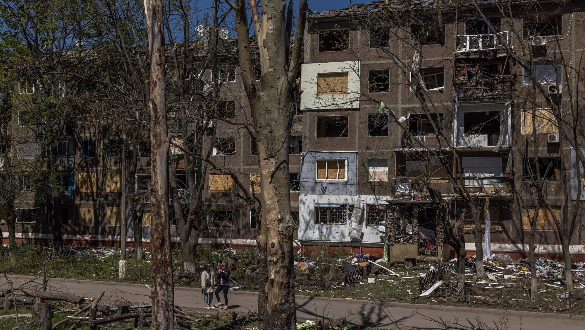 epa09930620 Women stand next to a damaged apartment building after the recent Russian airstrike, in Kramatorsk, Donetsk region, eastern Ukraine, 06 May 2022. After pulling back its army from near the capital Kyiv, Russia moved its main focus to the east of Ukraine, attacking it from different directions. On 24 February, Russian troops invaded Ukrainian territory starting a conflict that has provoked destruction and a humanitarian crisis. According to the United Nations High Commission for the Refugees (UNHCR) last report on the situation of Ukraine released on 05 May, more than 5.7 million refugees have fled Ukraine making this the fastest growing refugee crisis since World War II.  EPA/ROMAN PILIPEY