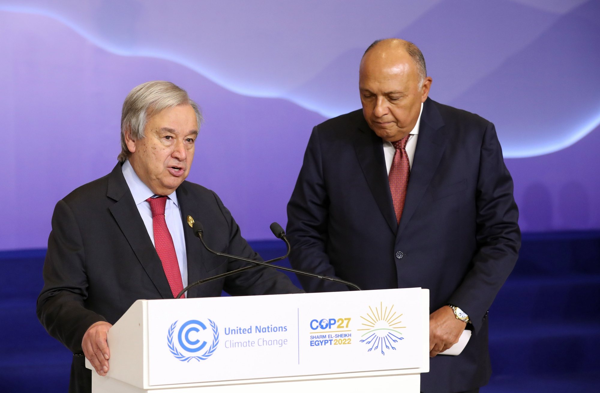 epa10310635 United Nations Secretary-General Antonio Guterres (L) speaks next to President of the COP27 climate summit Sameh Shoukry (R) during the COP27 UN Climate Summit in Sharm El-Sheikh, Egypt, 17 November 2022. The 2022 United Nations Climate Change Conference (COP27), runs from 06-18 November, and is expected to host one of the largest number of participants in the annual global climate conference as over 40,000 estimated attendees, including heads of states and governments, civil society, media and other relevant stakeholders will attend. The events will include a Climate Implementation Summit, thematic days, flagship initiatives, and Green Zone activities engaging with climate and other global challenges.  EPA/KHALED ELFIQI