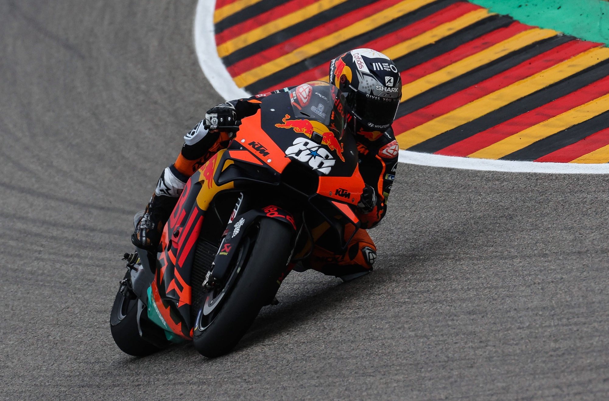 epa09288255 Portuguese MotoGP rider Miguel Oliveira of the Red Bull KTM Factory Racing team is on his way to take the second place in the Motorcycling Grand Prix of Germany at the Sachsenring racing circuit in Hohenstein-Ernstthal, Germany, 20 June 2021.  EPA/FILIP SINGER