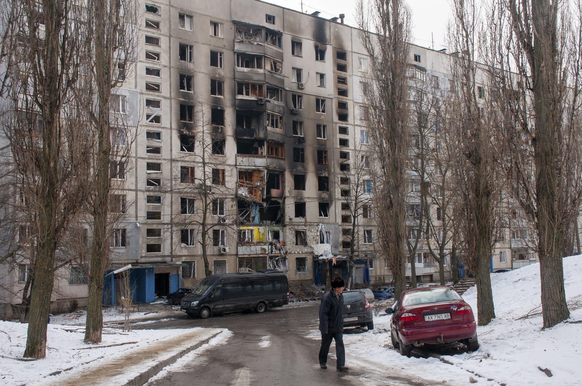 epaselect epa09810163 A man walks past destroyed residential building after shelling in Eastern Ukrainian city of Kharkiv, Ukraine, 08 March 2022. According to the United Nations High Commissioner for Refugees (UNHCR), Russia&#039;s military invasion of Ukraine, which started on 24 February, has caused destruction of civilian infrastructure as well as civilian casualties, with tens of thousands internally displaced and over two million refugees fleeing Ukraine.  EPA/VASYL ZHLOBSKY