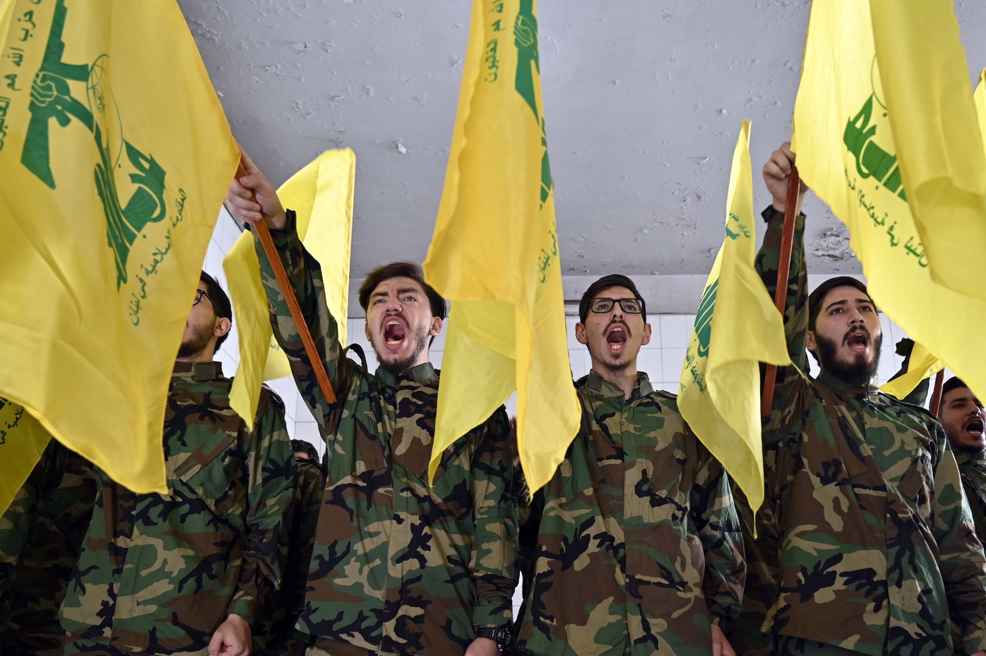 epa10960381 Hezbollah militants shout slogans during the funeral of Hezbollah fighter Qasim Ibrahim Abu Taam, who was killed a previous day in southern Lebanon, in the southern suburb of Beirut, Lebanon, 06 November 2023. Tensions remain high at the border between Israel and Lebanon after the Israeli-Palestinian conflict escalated following an unprecedented attack carried out by Hamas militants from Gaza into Israel on 07 October 2023.  EPA/WAEL HAMZEH