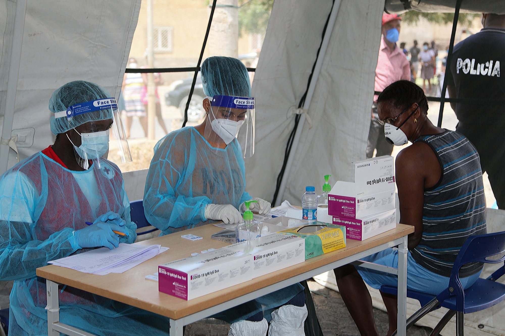 Pprofissionais de Saúde conversam com uma popular numa das tendas instaladas em vários bairros da cidade da Praia, onde estão a ser realizados testes rápidos de pesquisa de anticorpos ao coronavírus (covid-19), na Praia, Cabo Verde, 05 de junho de 2020. FERNANDO DE PINA/LUSA