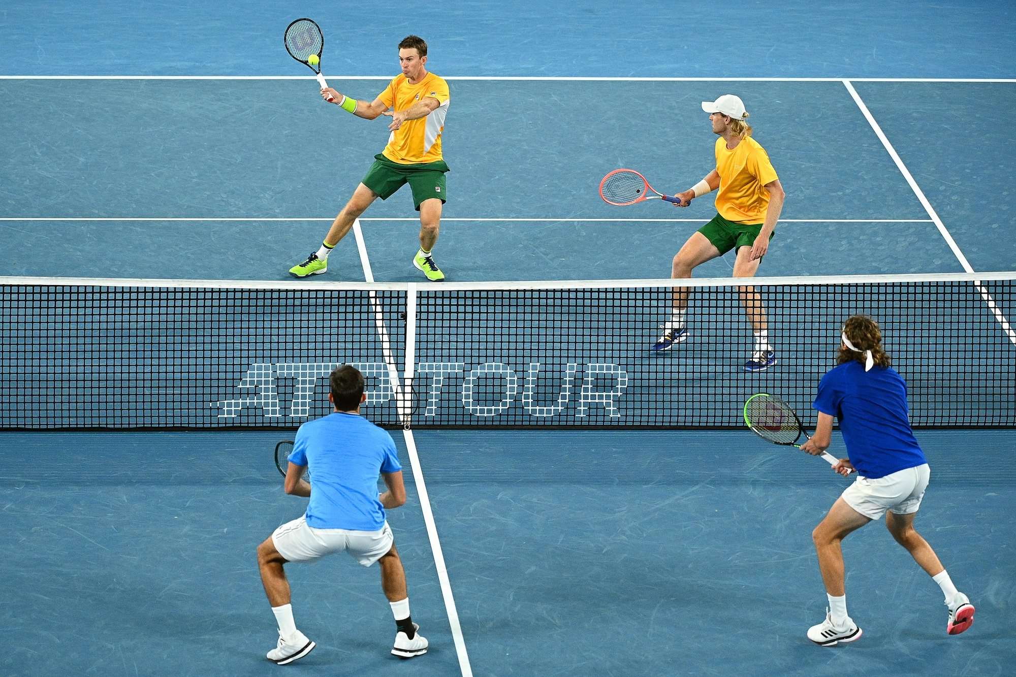 epa08984230 John Peers (back L) and Luke Saville (back R) of Australia in action against Stefanos Tsitsipas (front R) and Michail Pervolarakas (front L) of Greece during their doubles group stage match of the ATP Cup tennis tournament at Melbourne Park in Melbourne, Australia, 03 February 2021.  EPA/DEAN LEWINS AUSTRALIA AND NEW ZEALAND OUT