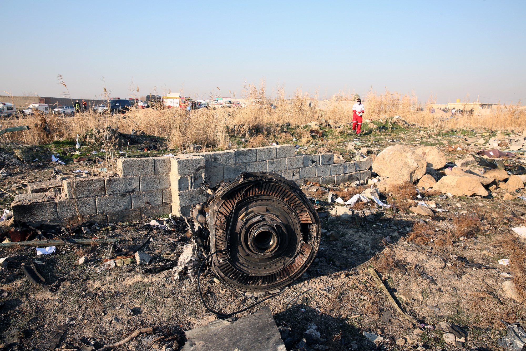 epa08922657 (FILE) - One of the engine of the plane lies among the wreckage after an Ukraine International Airlines Boeing 737-800 carrying 176 people crashed near Imam Khomeini Airport in Tehran, killing everyone on board, in Shahriar, Iran, 08 January 2020 (reissued 06 January 2021). A Ukrainian International Airlines passenger plane was downed by Iranian armed forces on 08 January 2020 near Tehran, killing all 176 people aboard, after allegedly mistaking it for an incoming missile.  EPA/ABEDIN TAHERKENAREH *** Local Caption *** 55751015