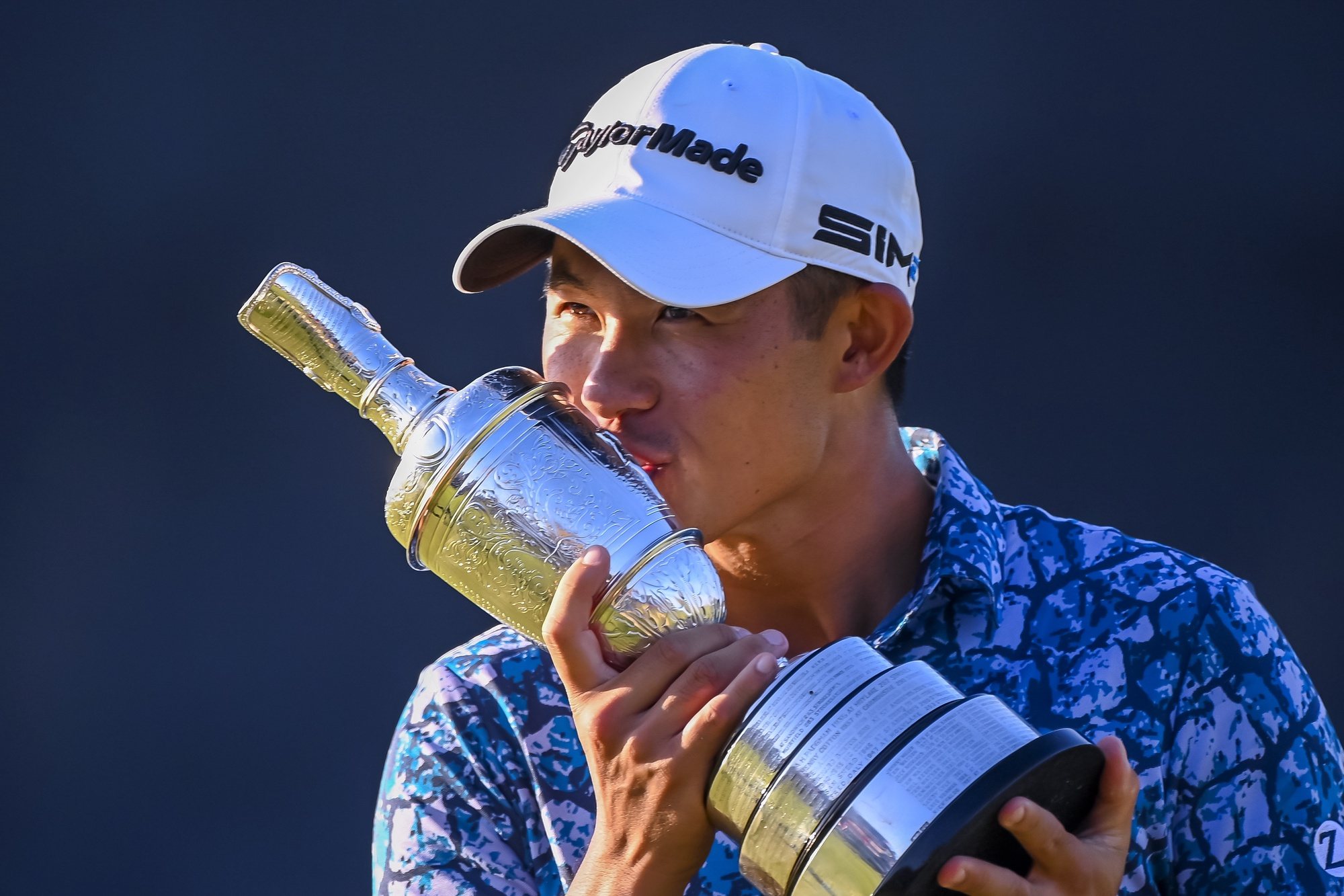epa09352529 Collin Morikawa of the US kisses the Claret Jug after winning The Open 2021 golf championship at Royal St George&#039;s golf course in Sandwich, Kent, Britain, 18 July 2021.  EPA/NEIL HALL
