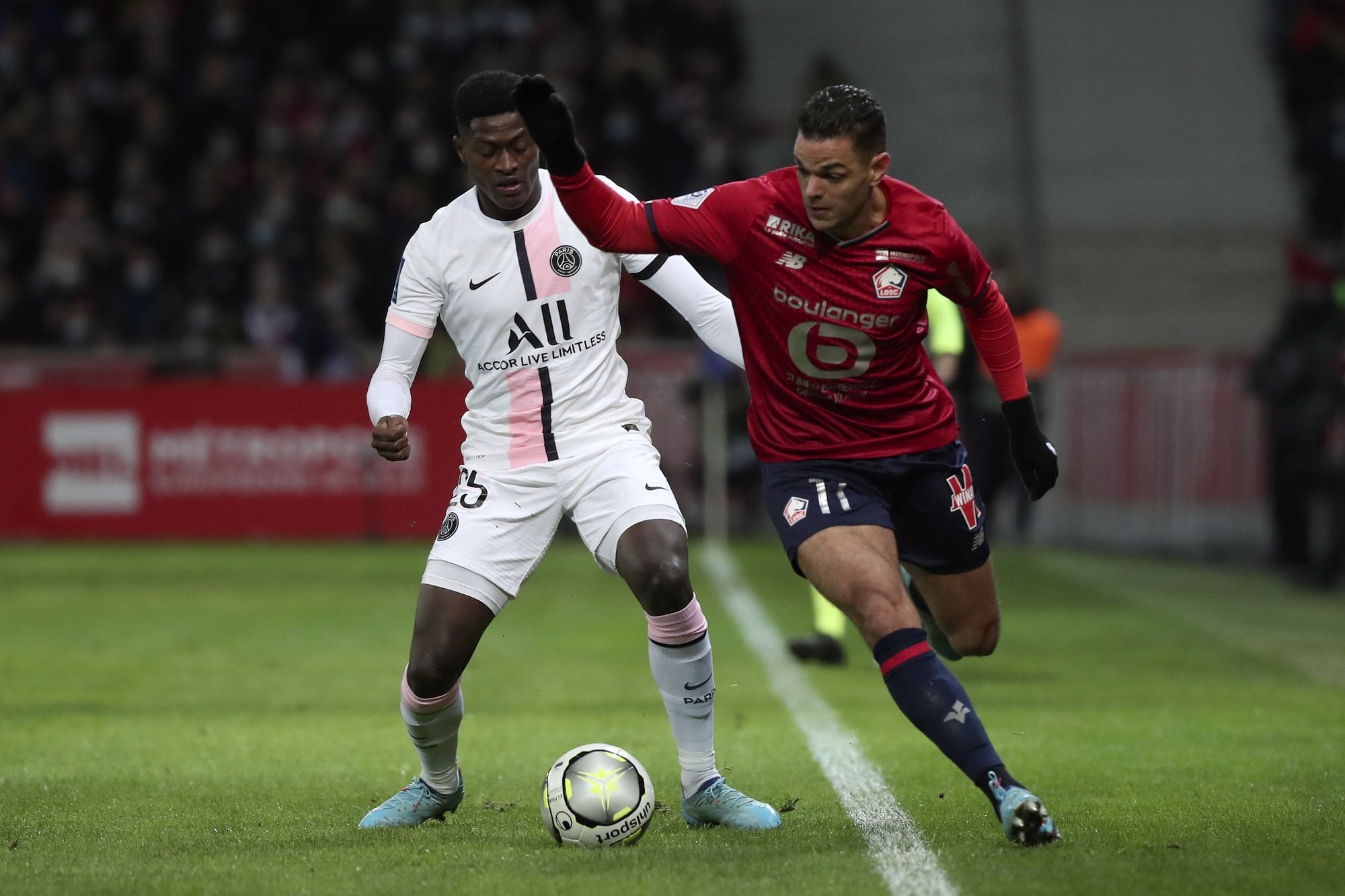 epa09733650 Lille&#039;s Hatem Ben Arfa (R) and Paris Saint Germain&#039;s Nuno Mendes (L) in action during the French Ligue 1 soccer match between Lille and PSG in Lille, France, 06 February 2022.  EPA/CHRISTOPHE PETIT TESSON