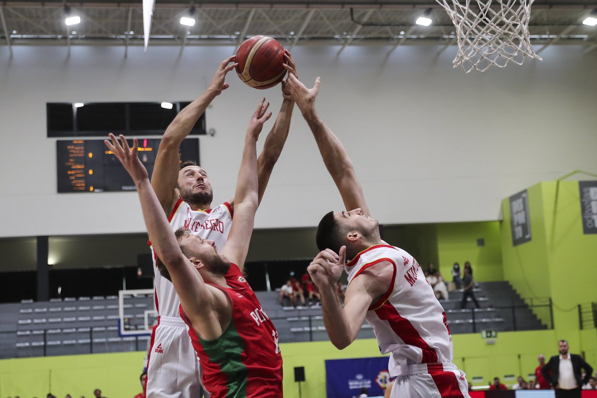 Portugal&#039;s Joao Guerreiro (C) fights for the ball with Montenegro&#039;s Aleksa Ilic (R) and Vladimir Mihailovic (L) during the FIBA Basketball World Cup 2023 Qualifier group E match at Odivelas Pavilion, outskirts Lisbon, Portugal, 4 of July 2022. MIGUEL A. LOPES/LUSA