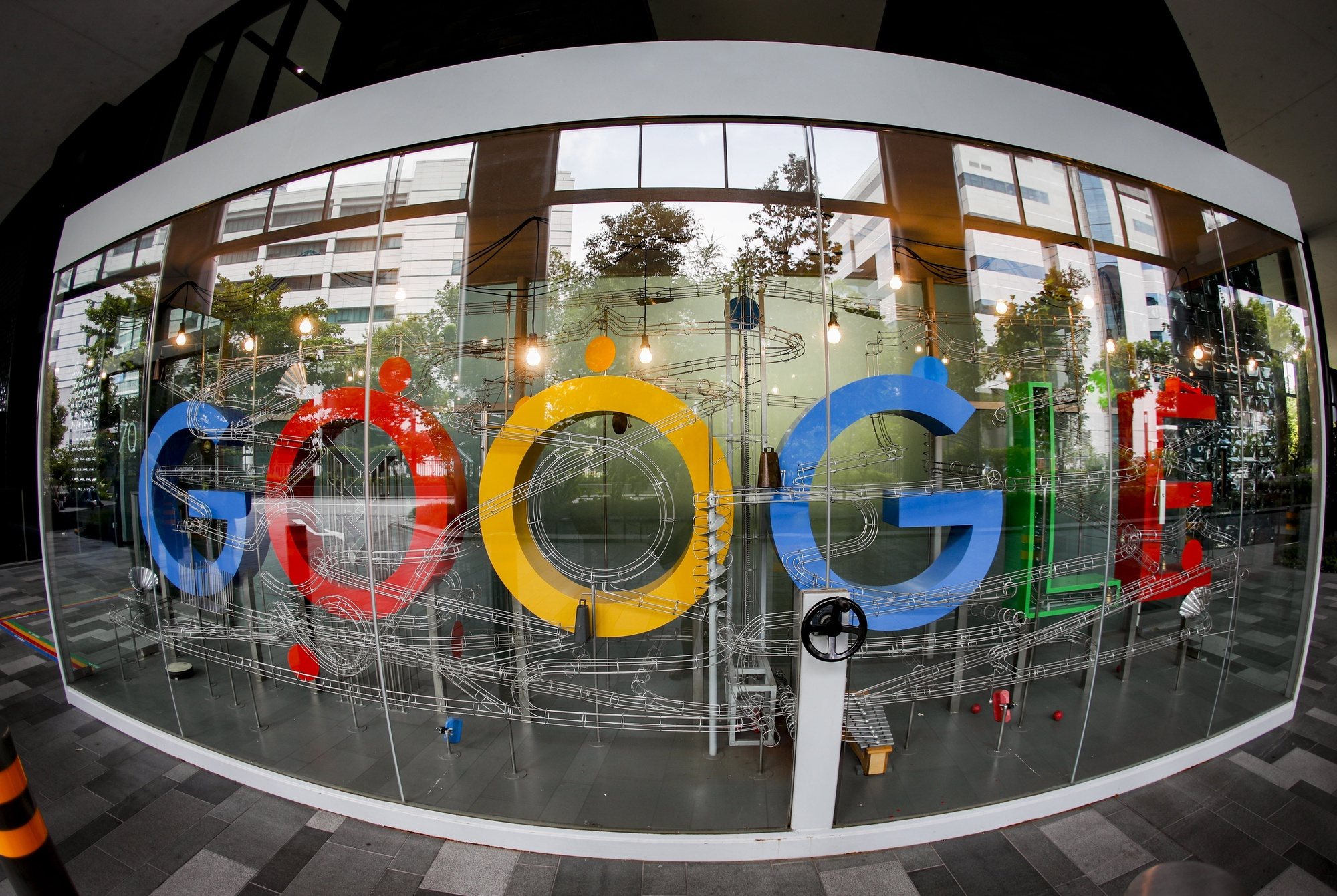 epa08873751 (FILE) A  picture made with a fisheye lens shows the Google logo in Singapore, 06 December 2019 (reissued 10 December 2020). According to media reports on 10 December 2020, French data privacy regulator CNIL will impose over 100 million euros fines on US companies Google and Amazon for breaching EU privacy data rules. According to media reports, Google will have to pay 100 million euros and Amazon 35 million euros fines.  EPA/WALLACE WOON *** Local Caption *** 55685412