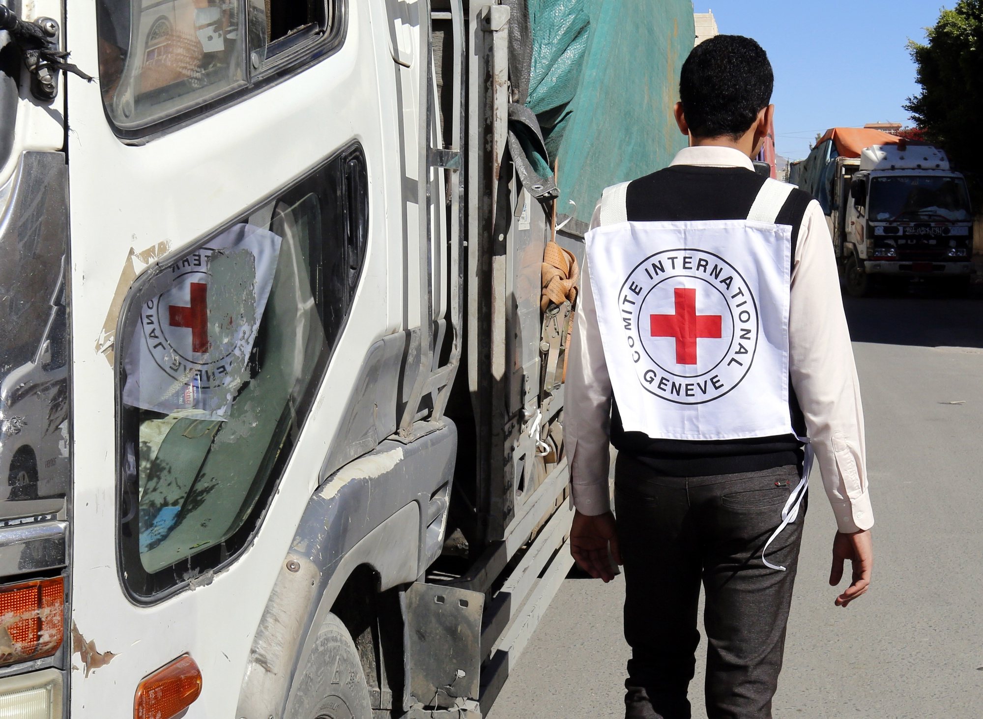 epa06791768 (FILE) - A member of staff from the International Committee of the Red Cross passes a truck carrying ICRC-provided emergency medical aid, in Sanaâ€™a, Yemen, 13 December 2017 (issued 07 June 2018). According to reports, the International Committee of the Red Cross (ICRC) has pulled 71 staff members out of Yemen amid rising insecurity in the war-torn Arab country.  EPA/YAHYA ARHAB