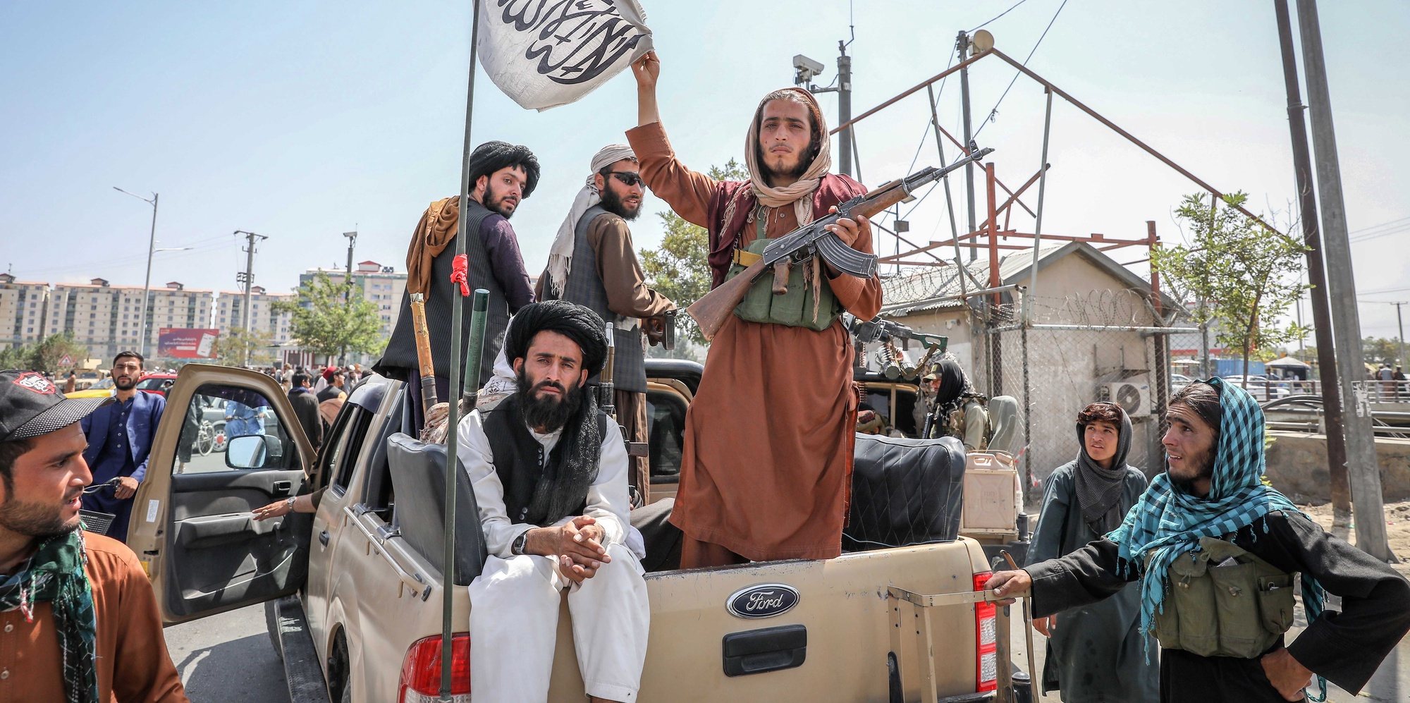 epa09416519 Taliban fighters are seen on the back of a vehicle in Kabul, Afghanistan, 16 August 2021. Taliban co-founder Abdul Ghani Baradar, on 16 August 2021, declared victory and an end to the decades-long war in Afghanistan, a day after the insurgents entered Kabul to take control of the country. Baradar, who heads the Taliban political office in Qatar, released a short video message after President Ashraf Ghani fled and conceded that the insurgents had won the 20-year war.  EPA/STRINGER