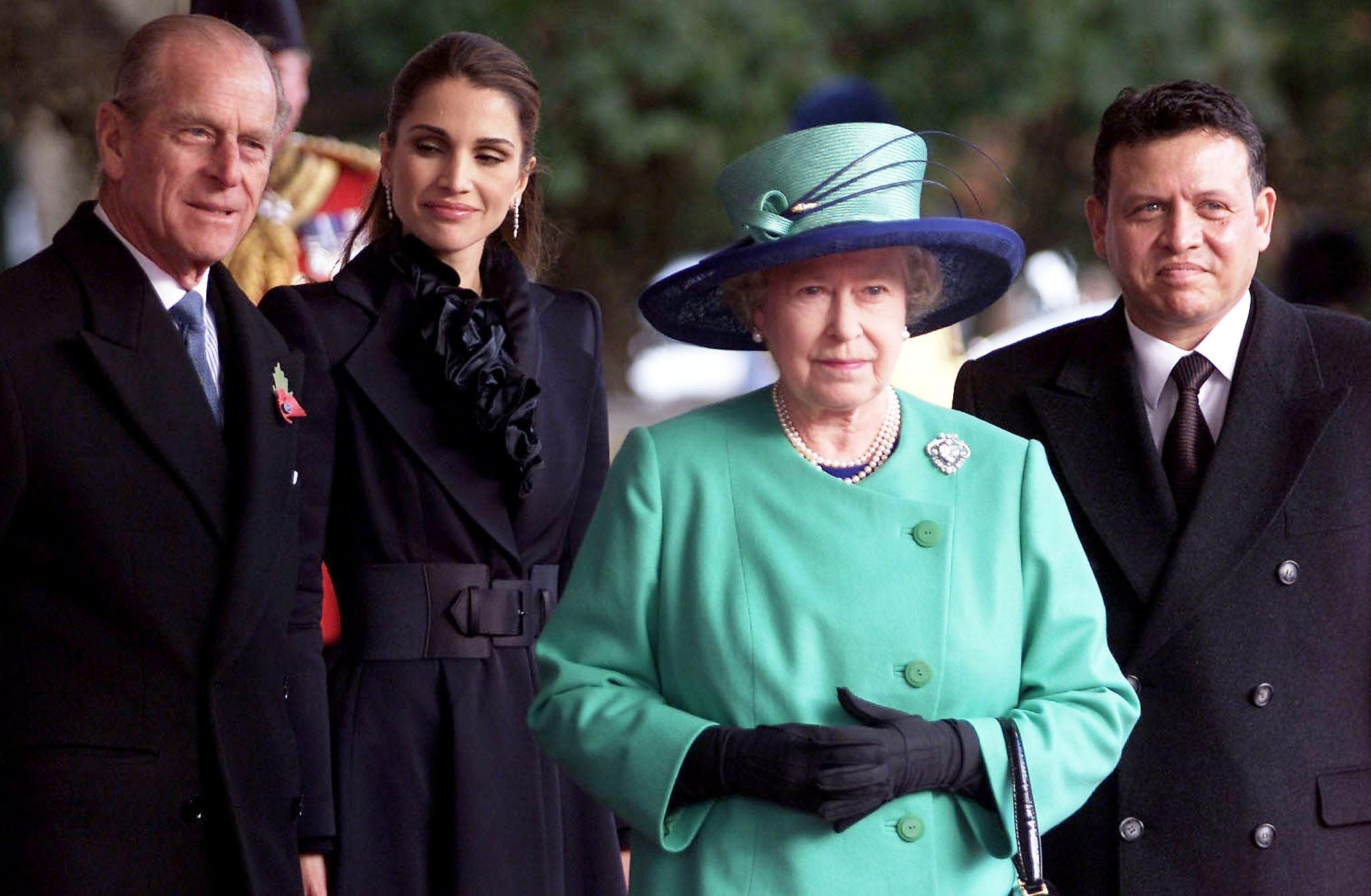 Britain&#039;s Queen Elizabeth II (3rd L) stands with K