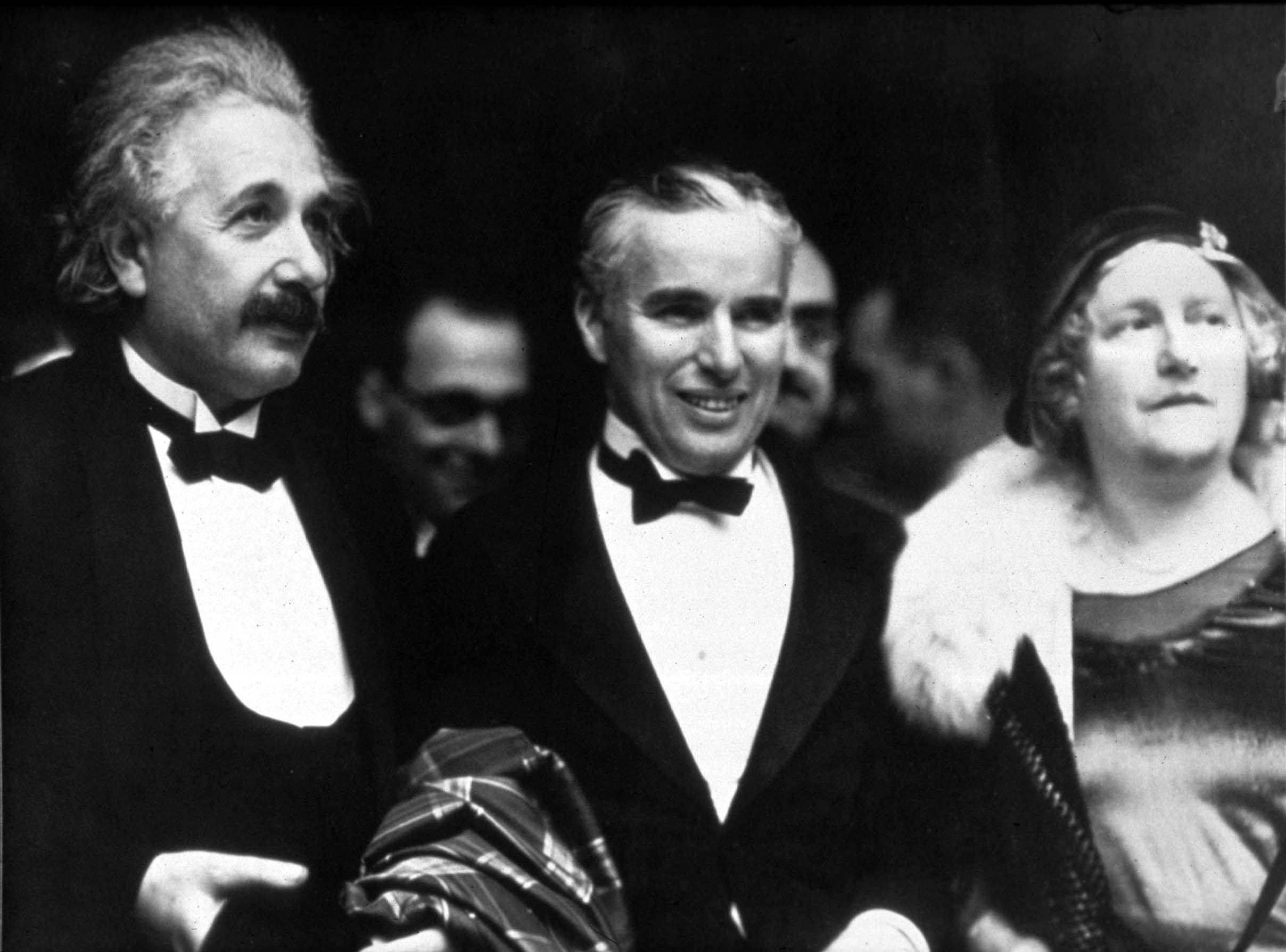 O físico Ablert Eintein (E) e a sua mulher, Elsa Einstein (D) com o ator e realizador Charles Chaplin (C)