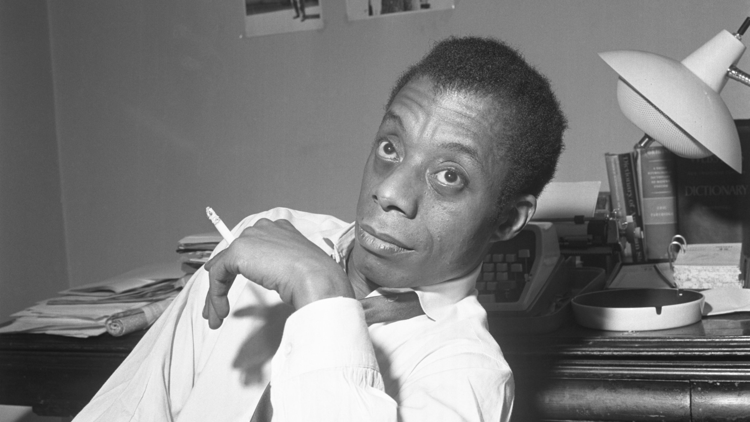James Baldwin Sitting Smoking A Cigarette
