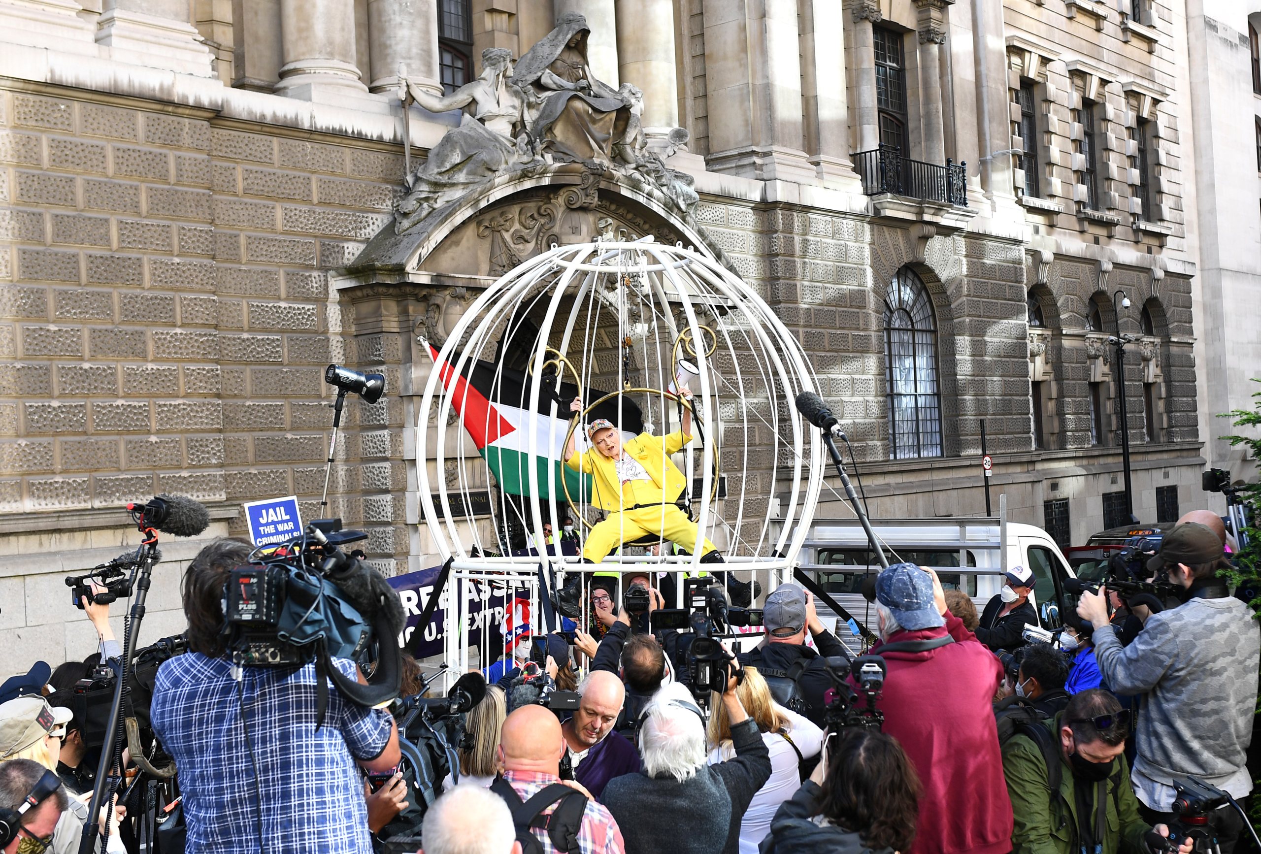 Dame Vivienne Westwood Suspends 10 Ft High Inside Giant Bird Cage In Protest For Julian Assange