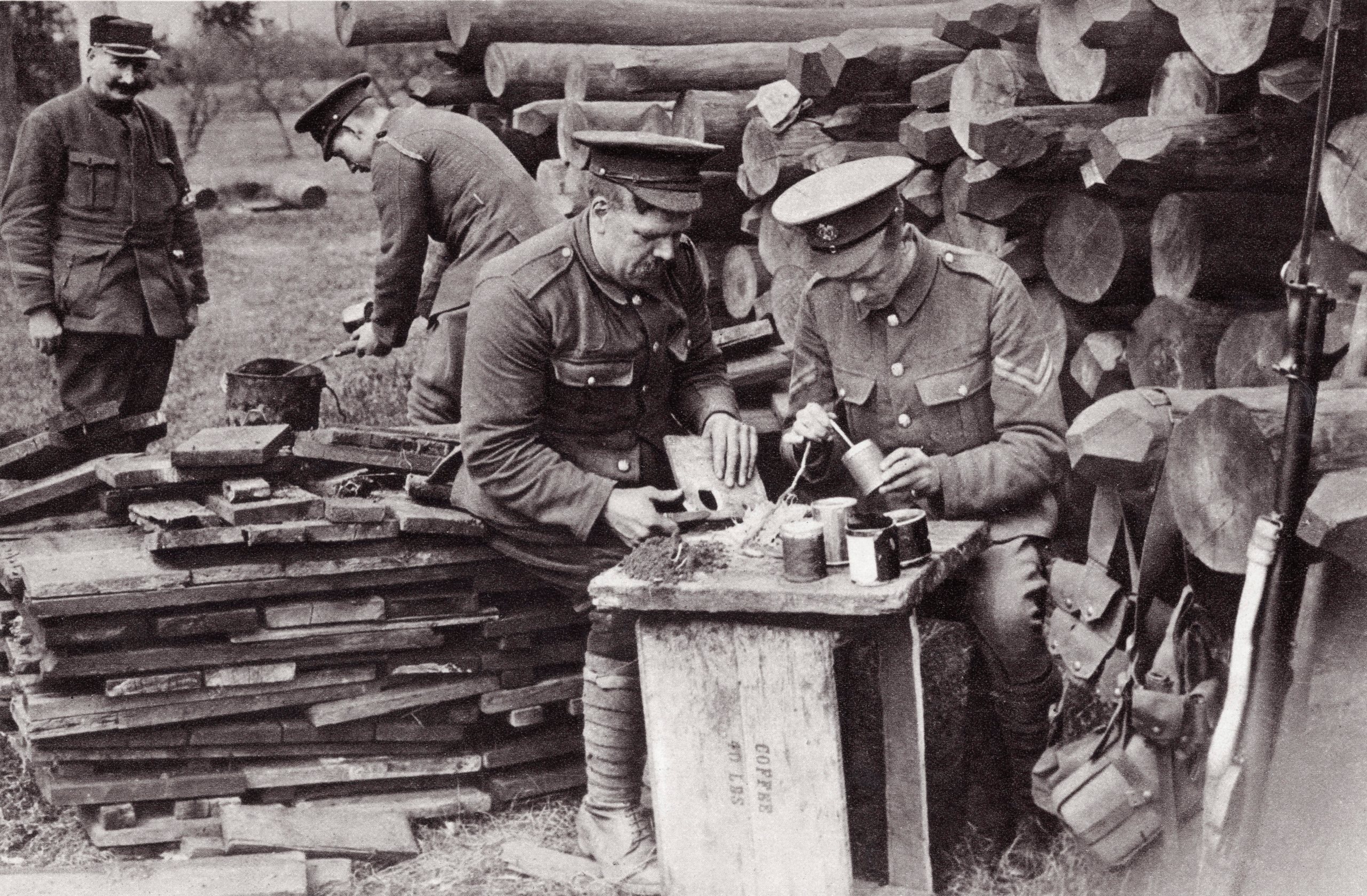Tobacco tins as hand grenades. Men of the Royal Engineers loading reserve stocks in rear of the trenches during the First World War. From The Illustrated War News published 1915