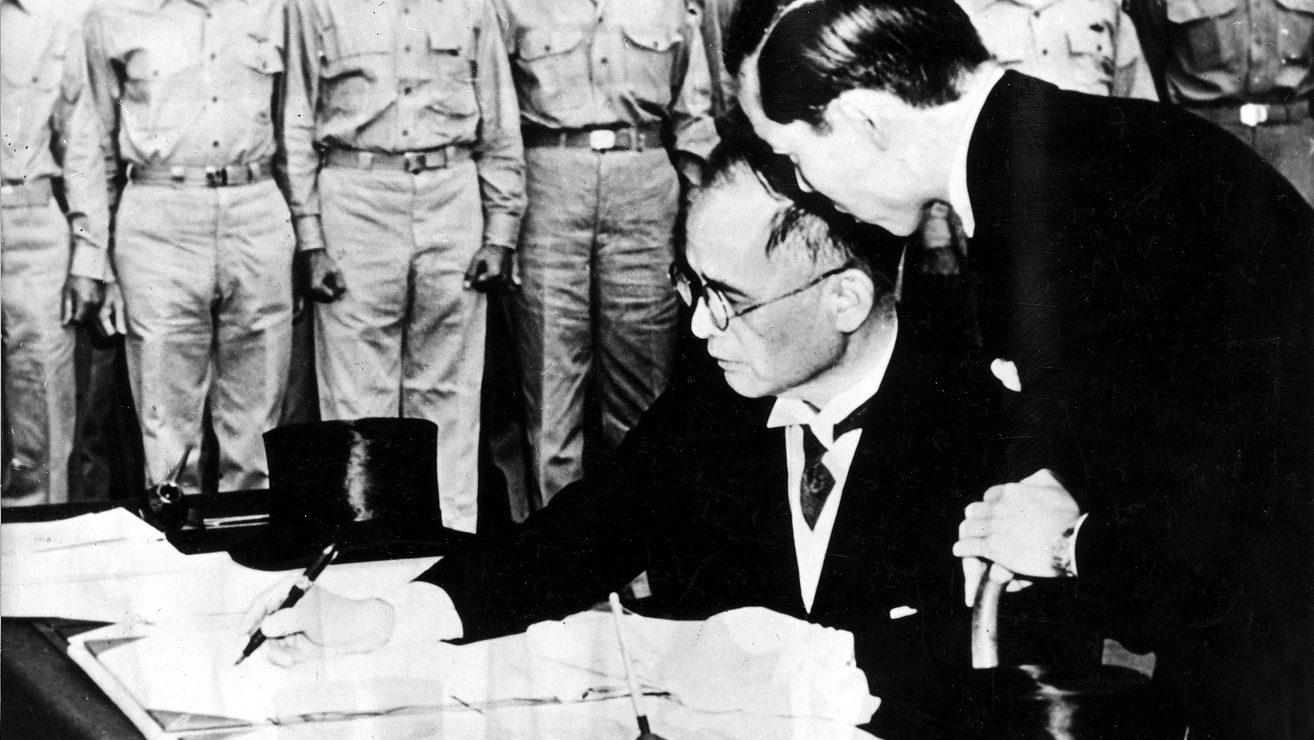 World War II in the Pacific Japanese Surrender aboard the USS Missouri in Tokyo Bay, September 2, 1945; the Japanese foreign minister Mamoru Shigemitsu is signing the surrender document