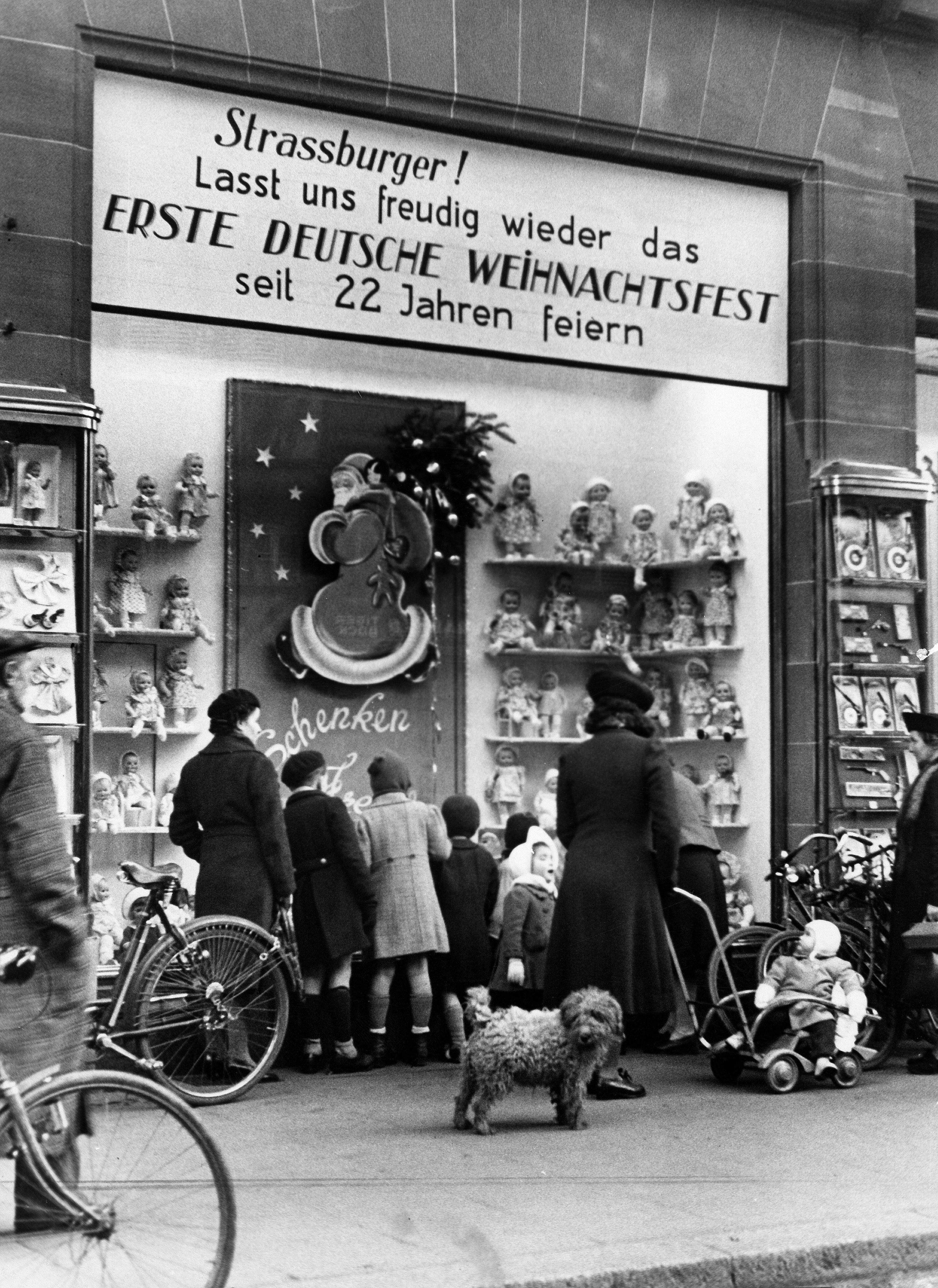 Strasbourg, Alsace (France) in 2. WW under german occupation: Shopwindow of a toys shop at christmas tide; text reads &#039;Strasbourgers ! let us joyfully celebrate again the first german chritmas since 22 years. December 1940