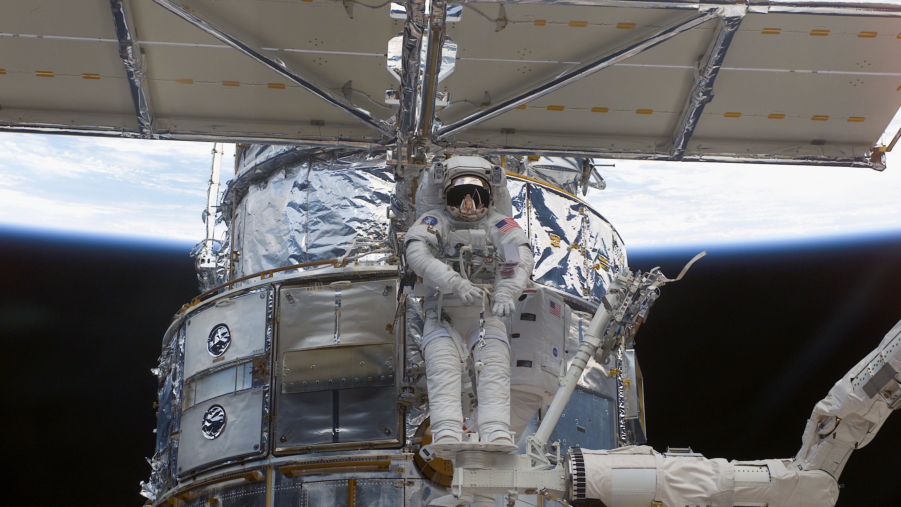 NASA Astronaut Works On Hubble Space Telescope