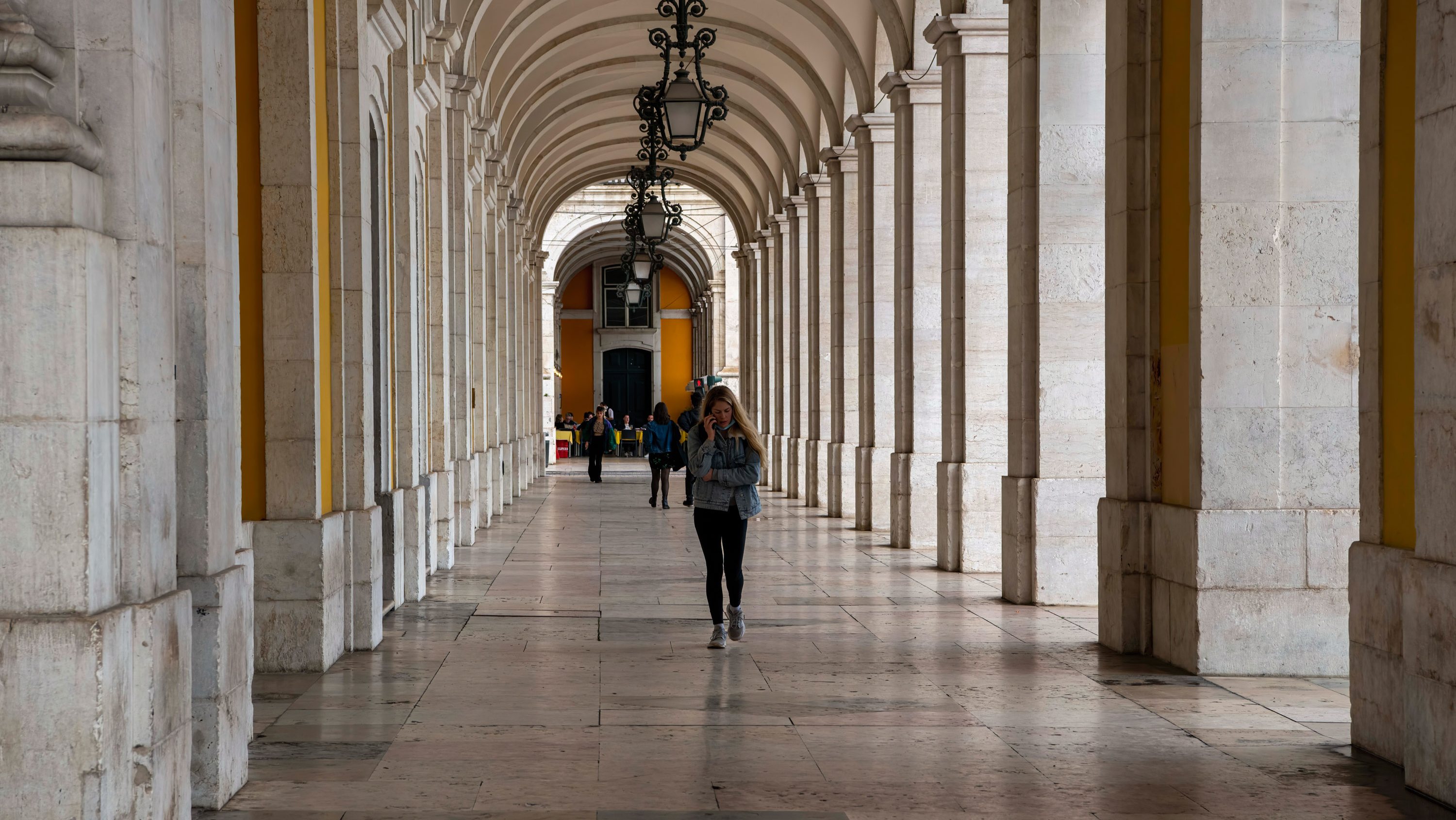 A person walks through the galleries around the historic