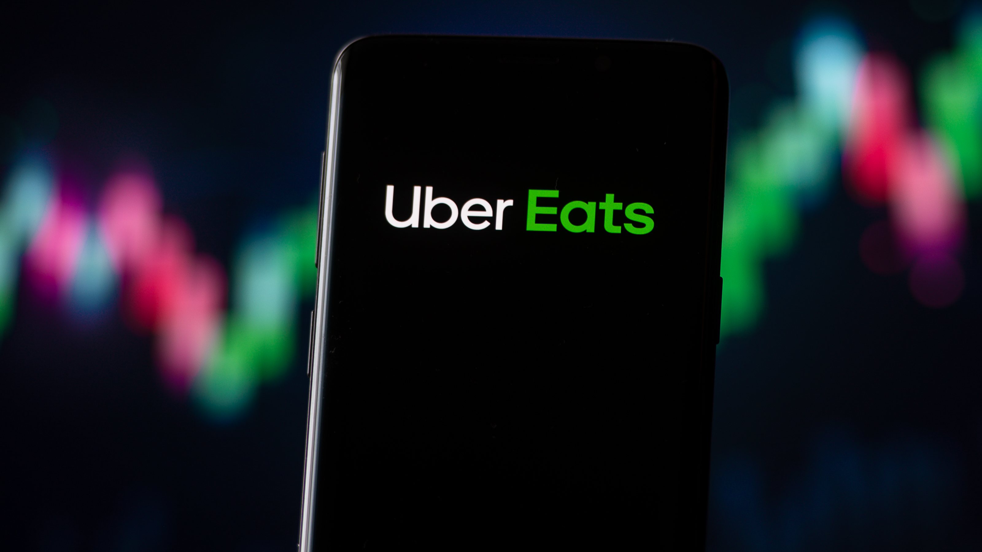 In this photo illustration an Uber Eats logo seen displayed