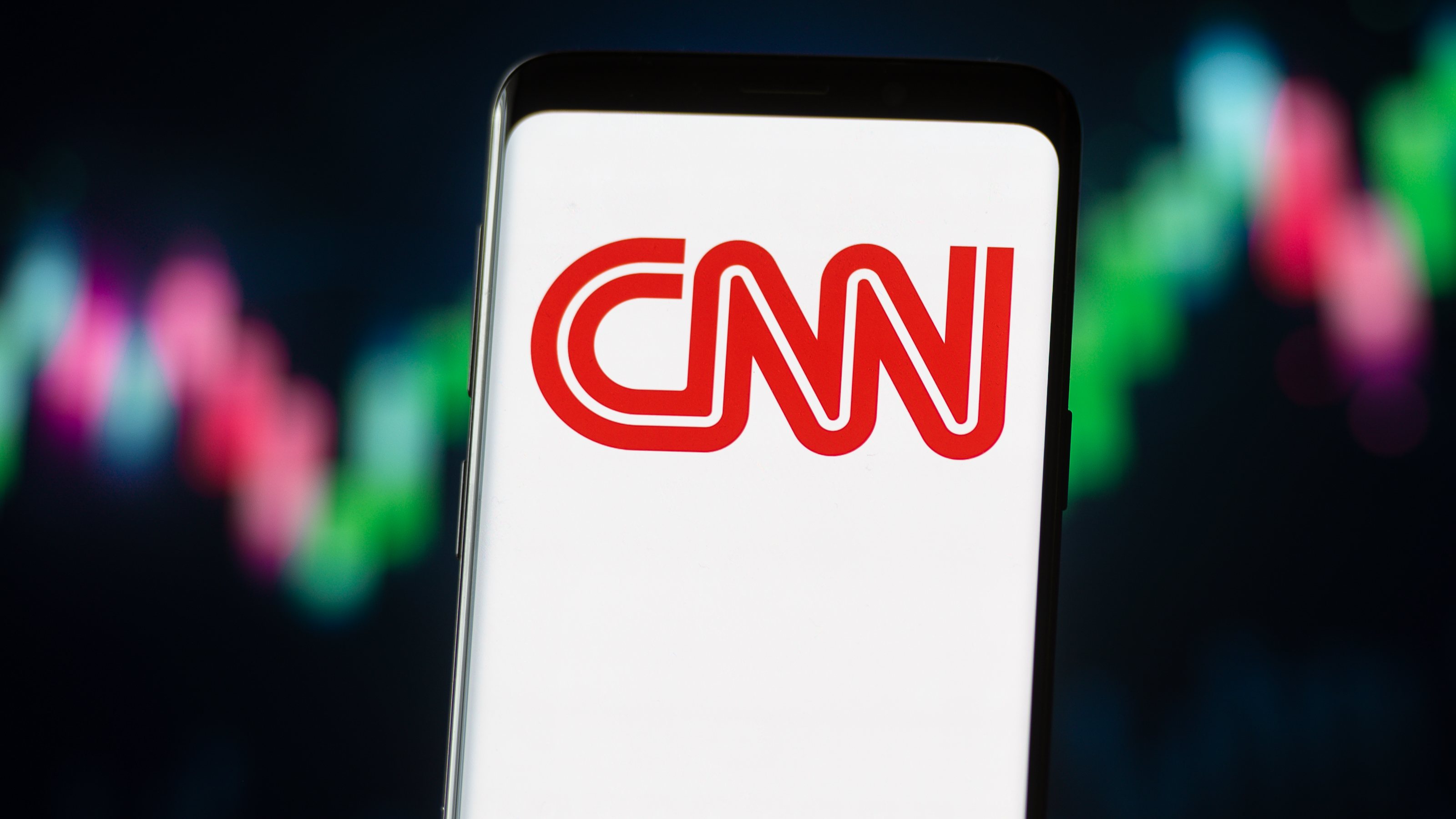 In this photo illustration a CNN logo seen displayed on a