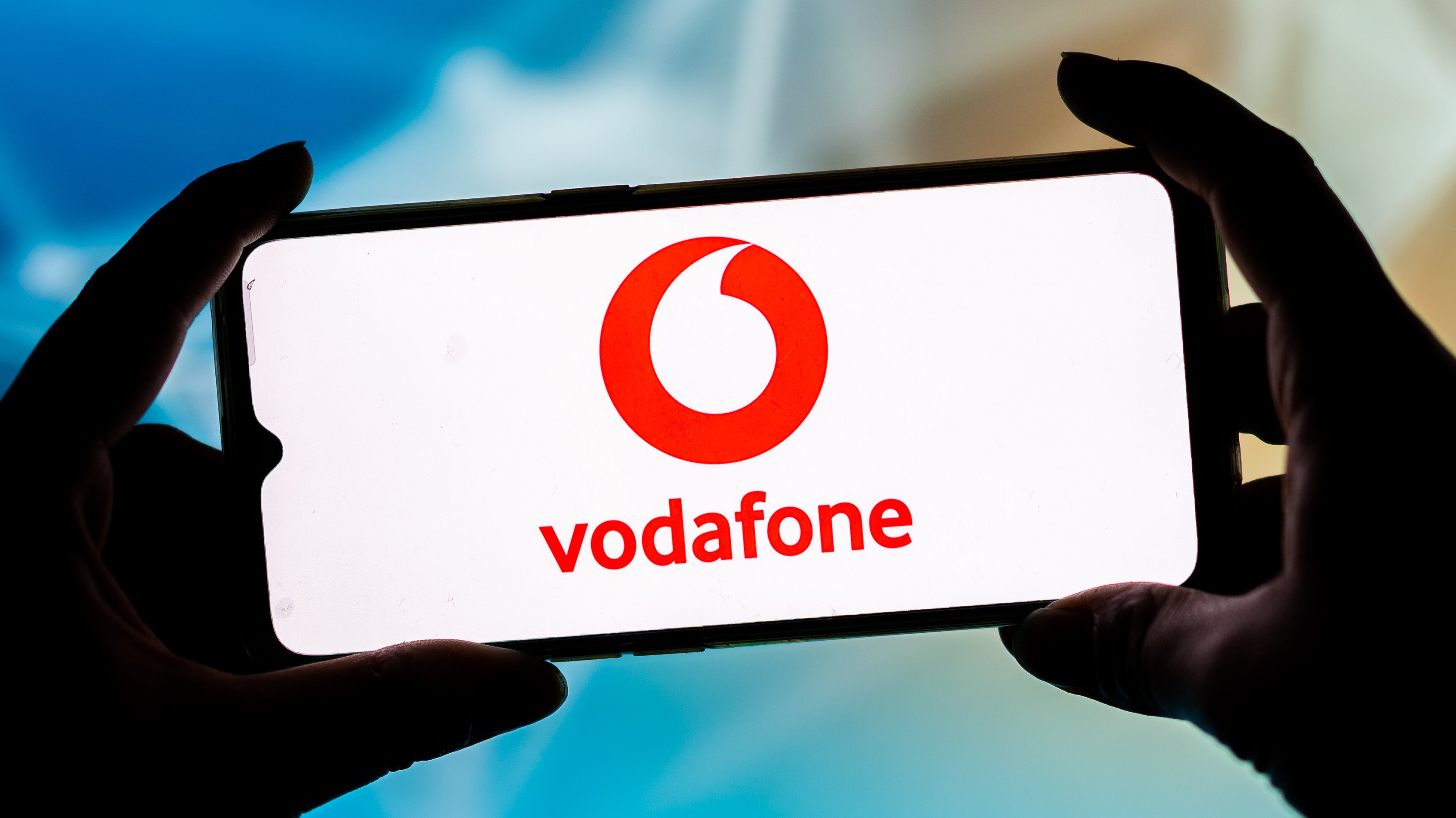 In this photo illustration a Vodafone logo seen displayed on