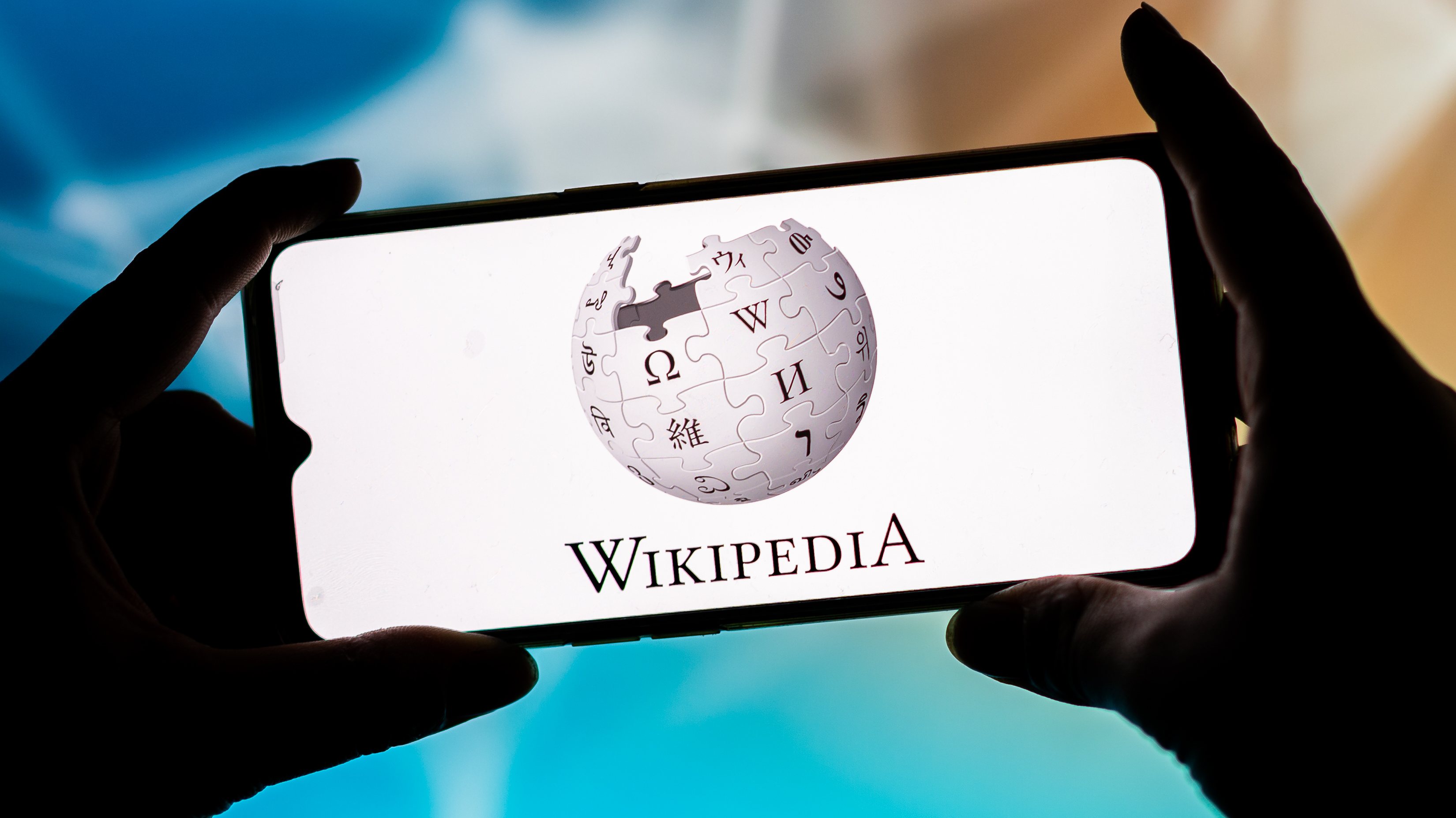 In this photo illustration, a Wikipedia logo seen displayed
