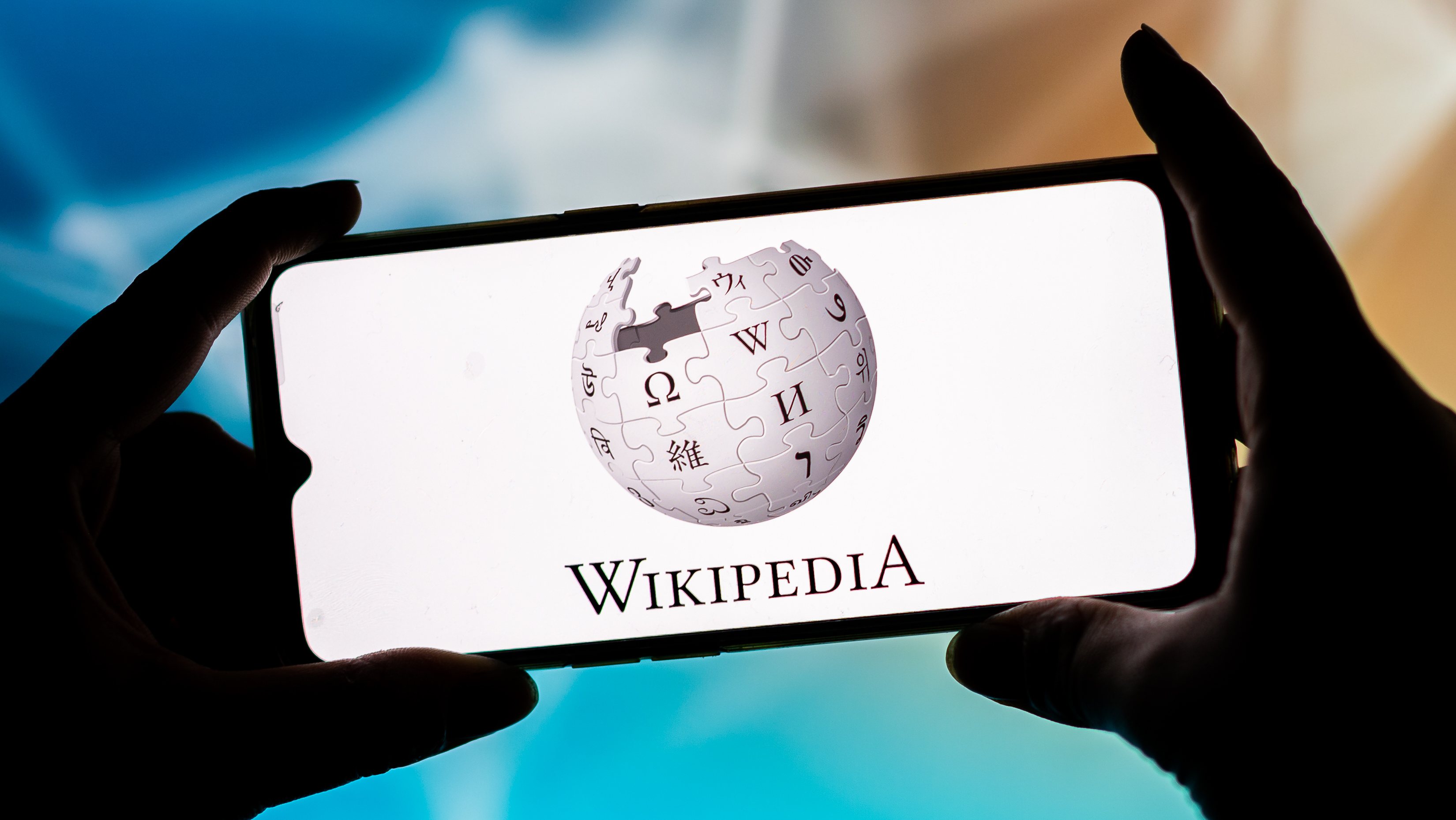 In this photo illustration, a Wikipedia logo seen displayed