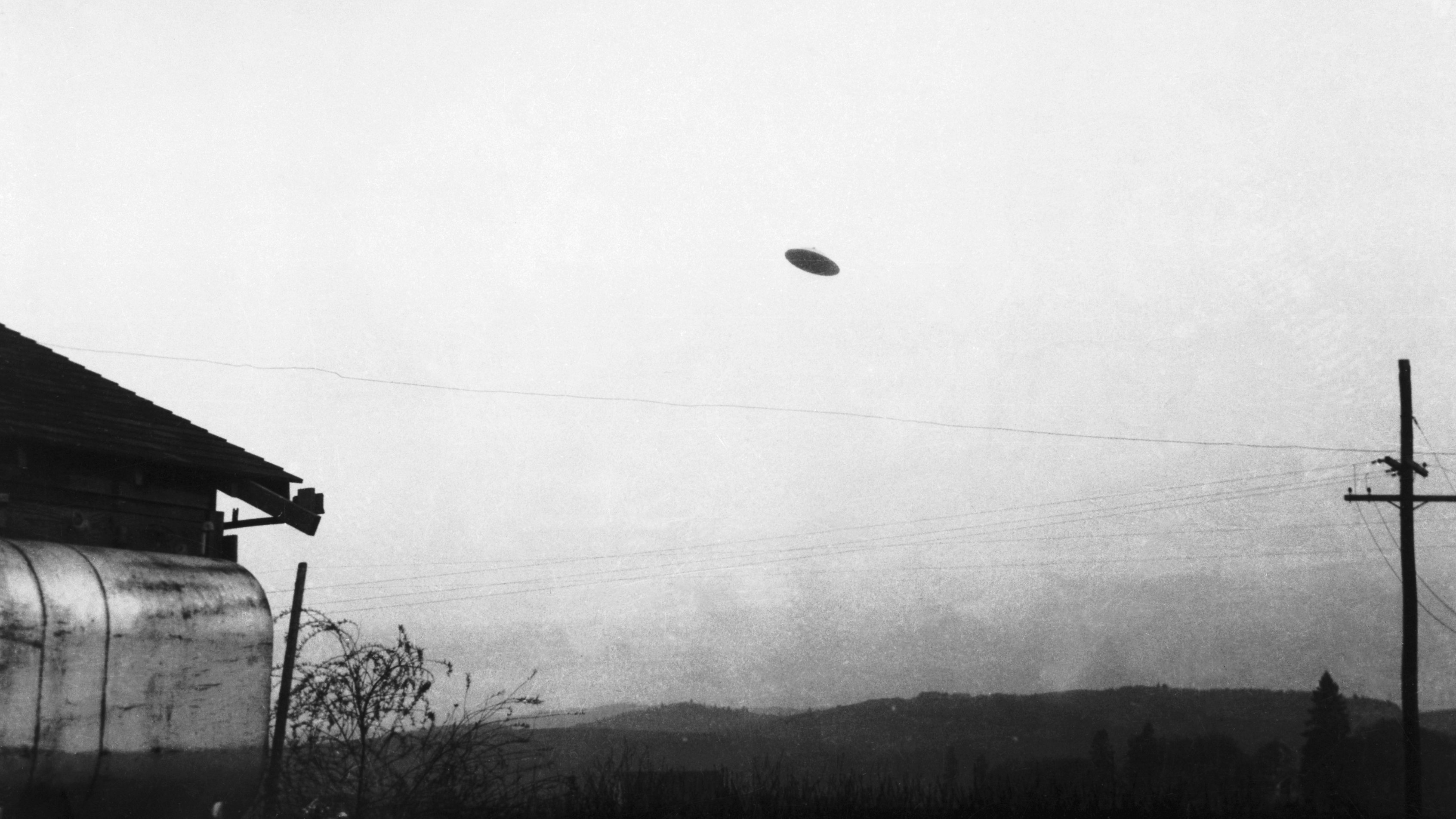 (Original Caption) 5/11/1950-Minnville, OR: A picture of a flying saucer photographed by farmer Paul Trent shown flying over his farm.