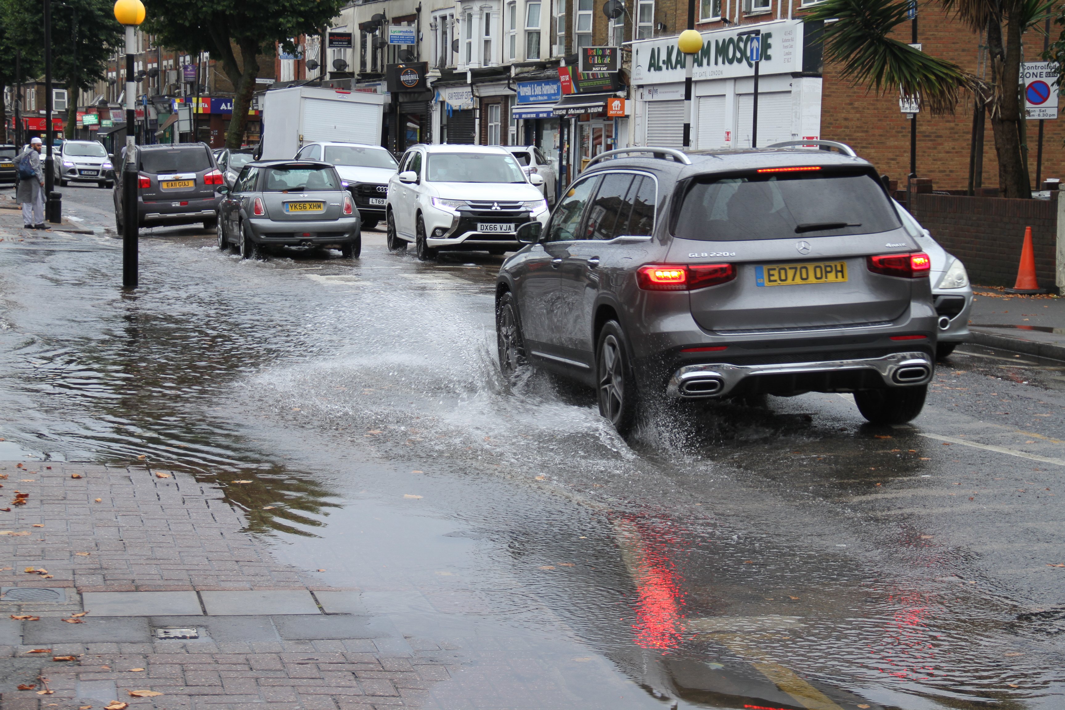 Traffic on a waterlogged road in East London  following