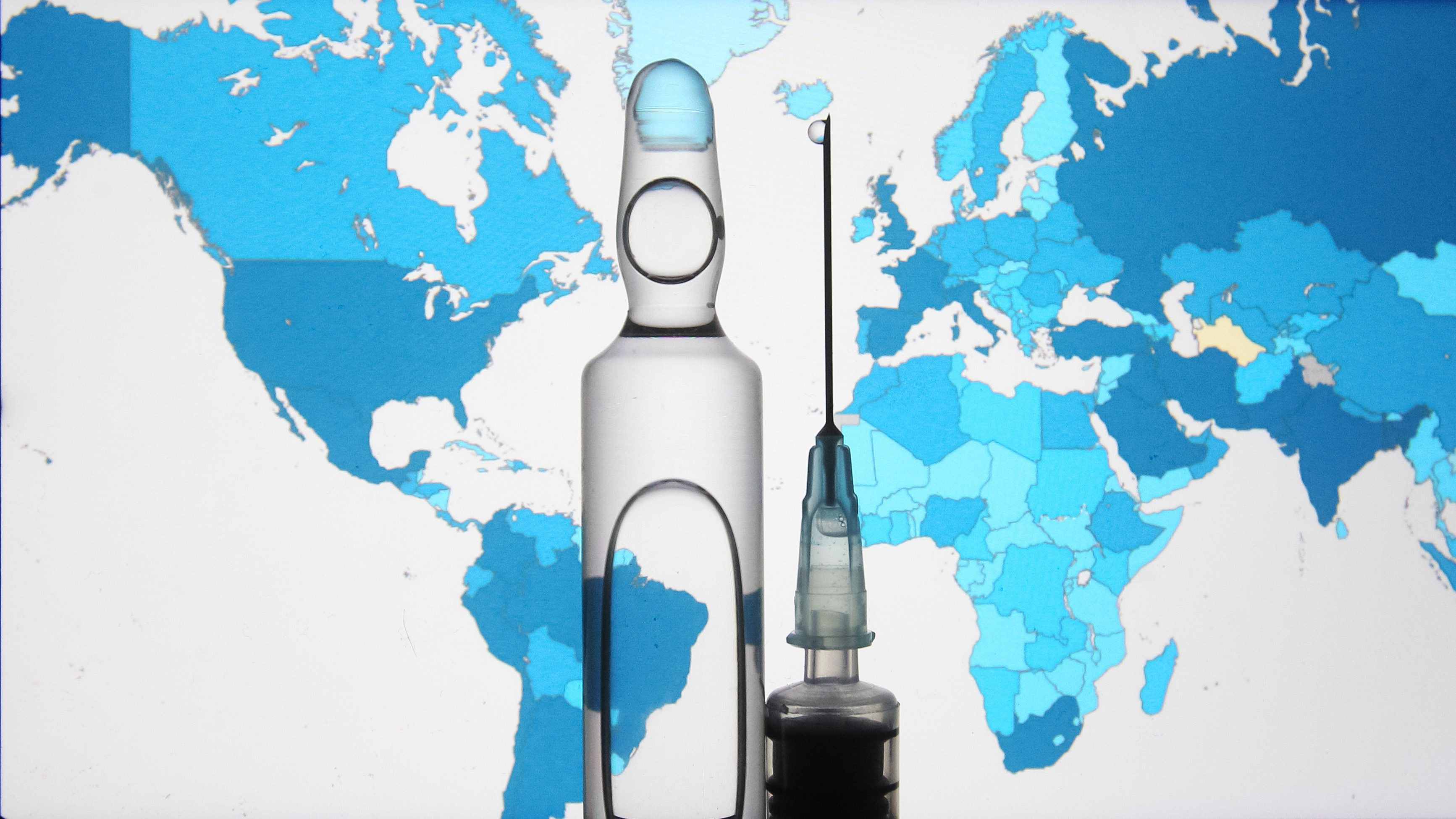 In this photo illustration a syringe and a small bottle with