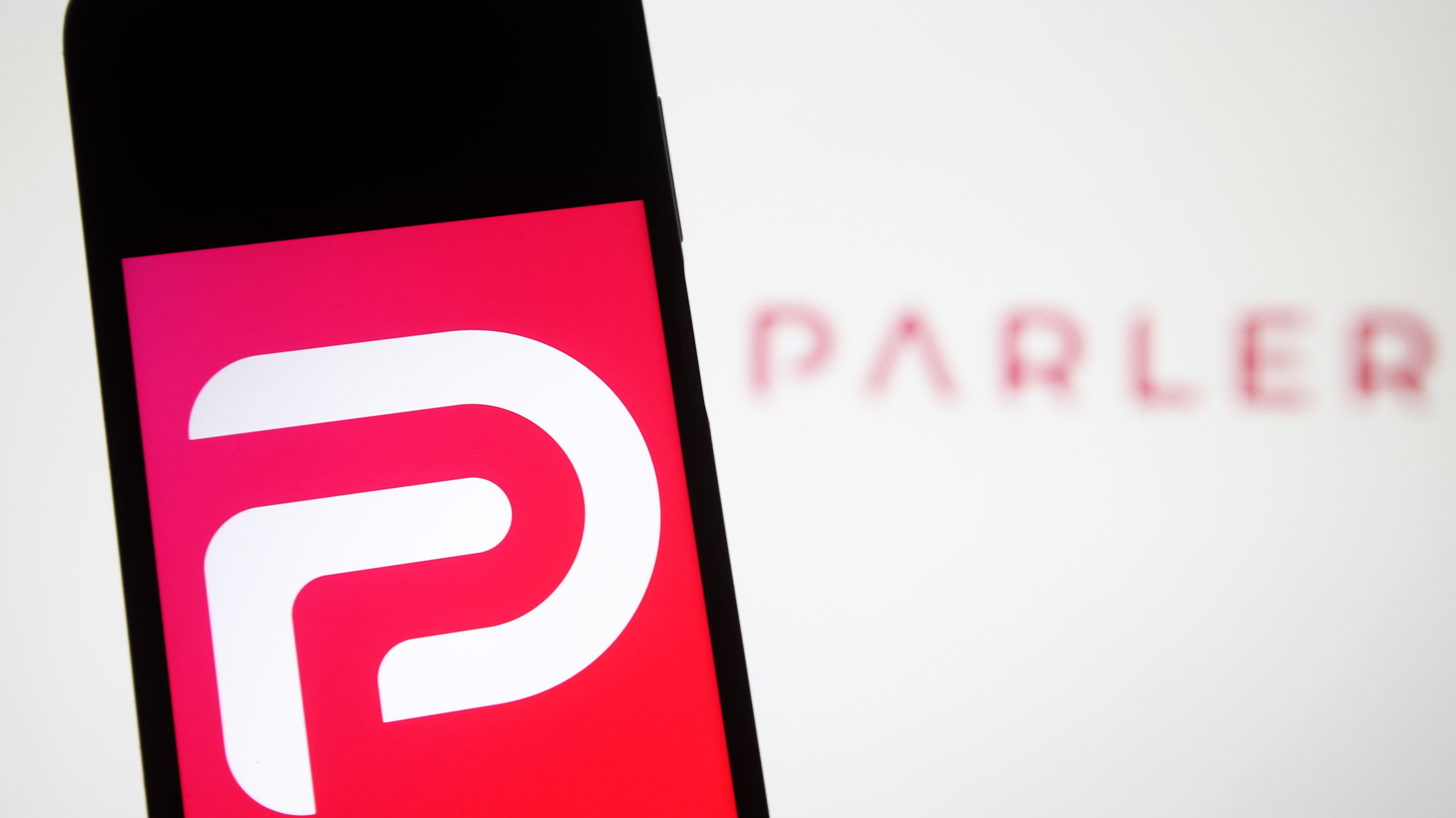 In this photo illustration the Parler logo seen displayed on