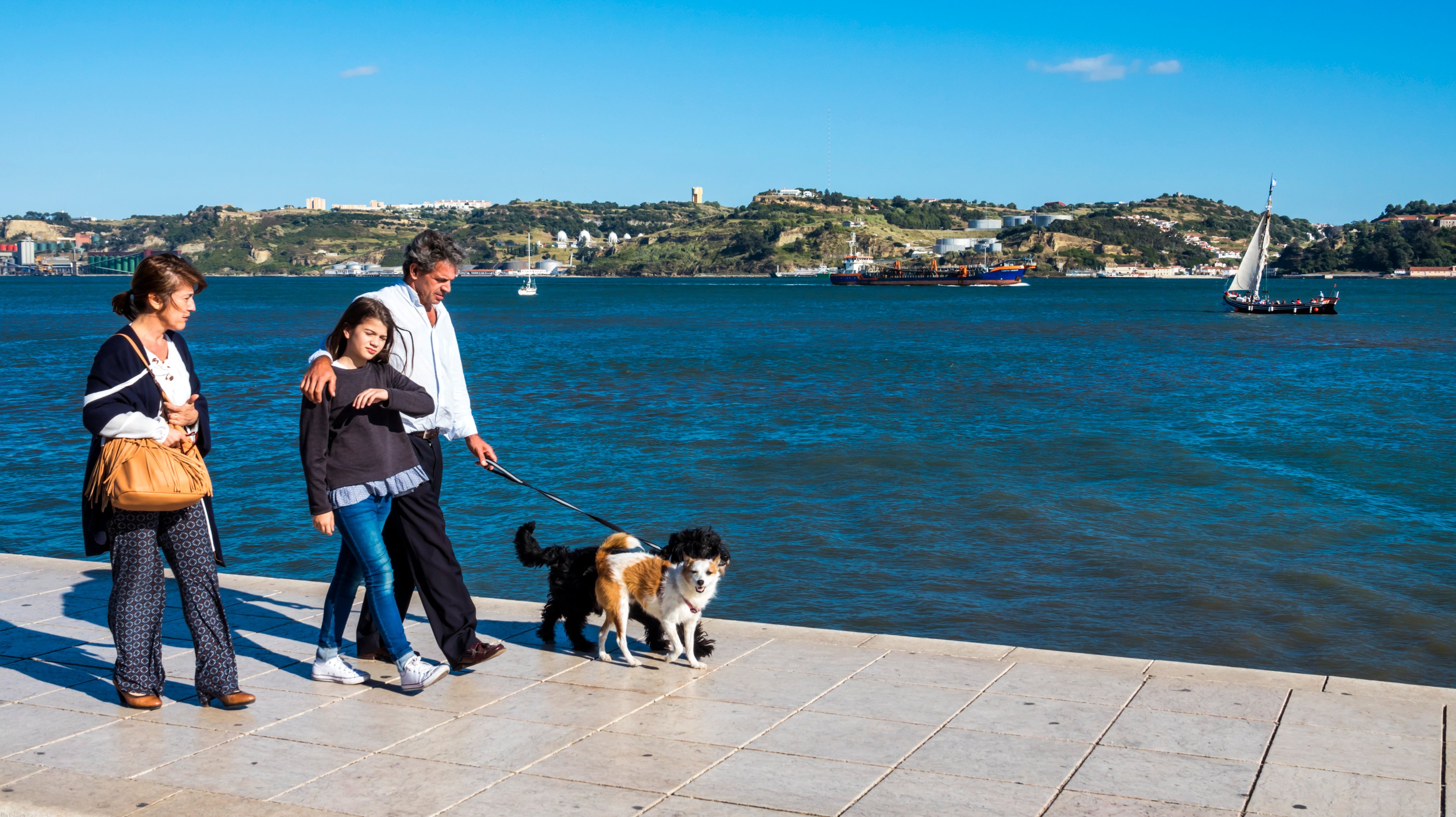 Portugal, Lisbon, Belem waterfront promenade couple walking dog