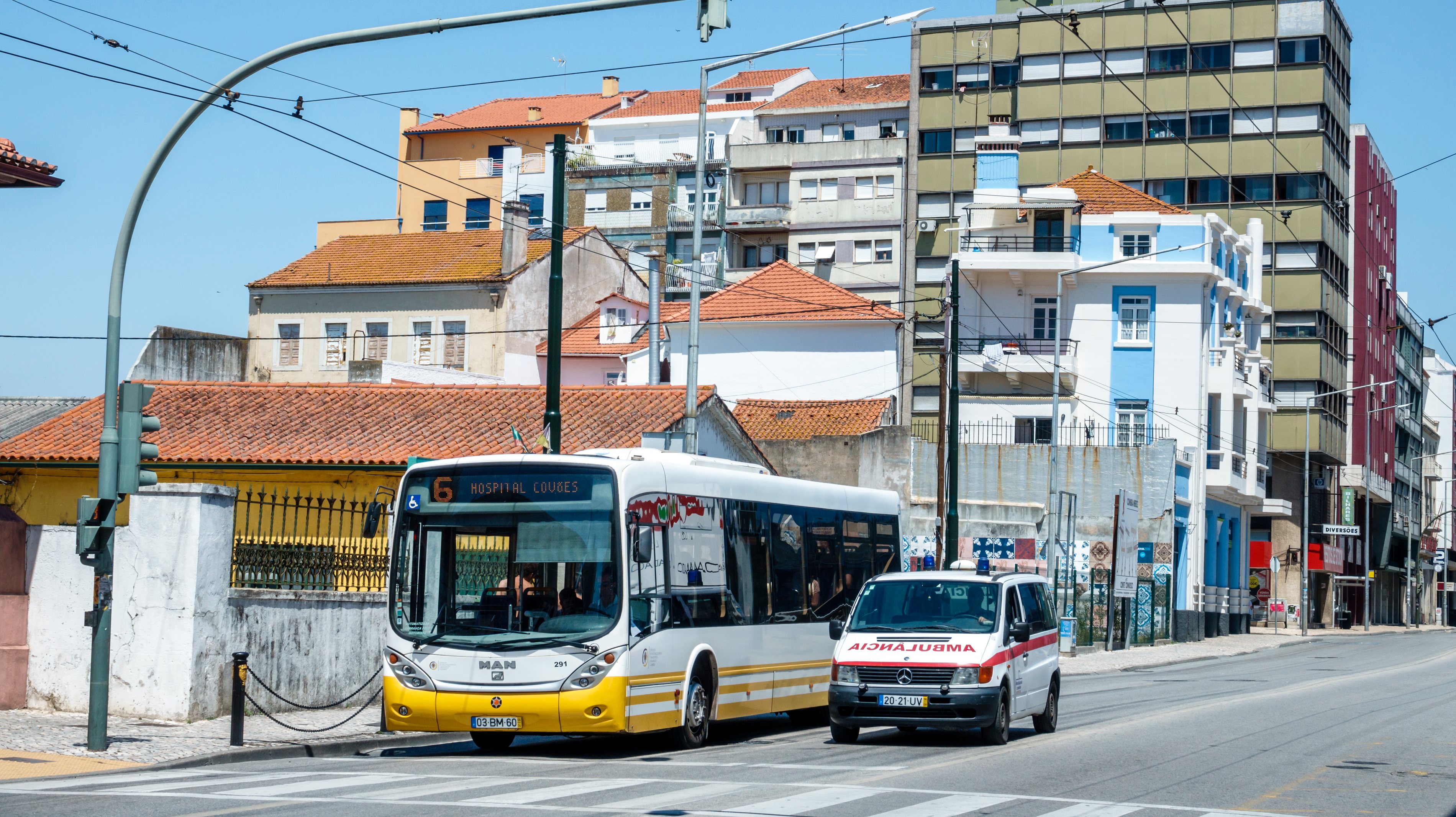 Portugal, Coimbra, Avenida Fernao de Magalhaes, intersection with bus and ambulance