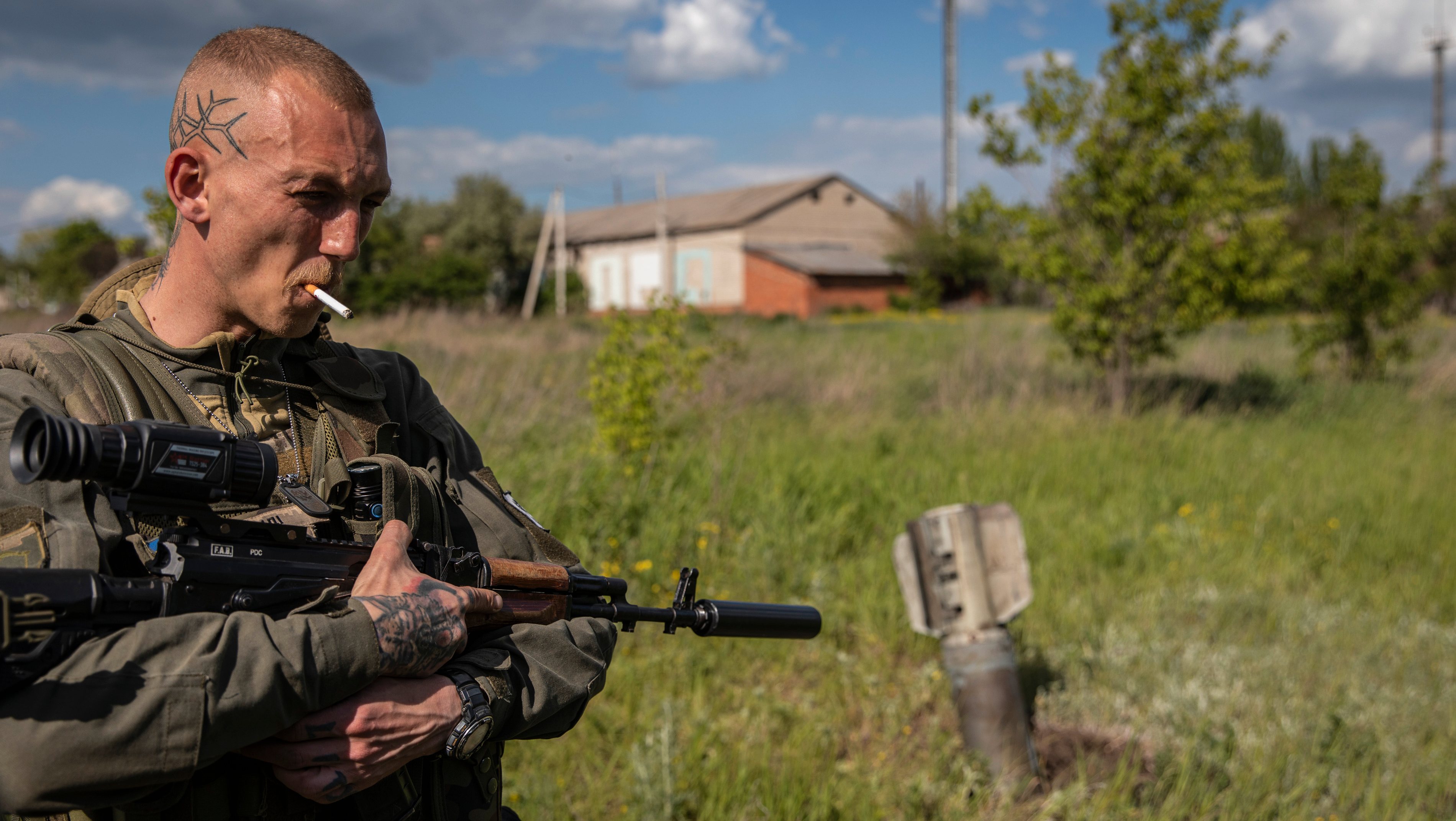 A Ukrainian soldier smokes a cigarette after checking the