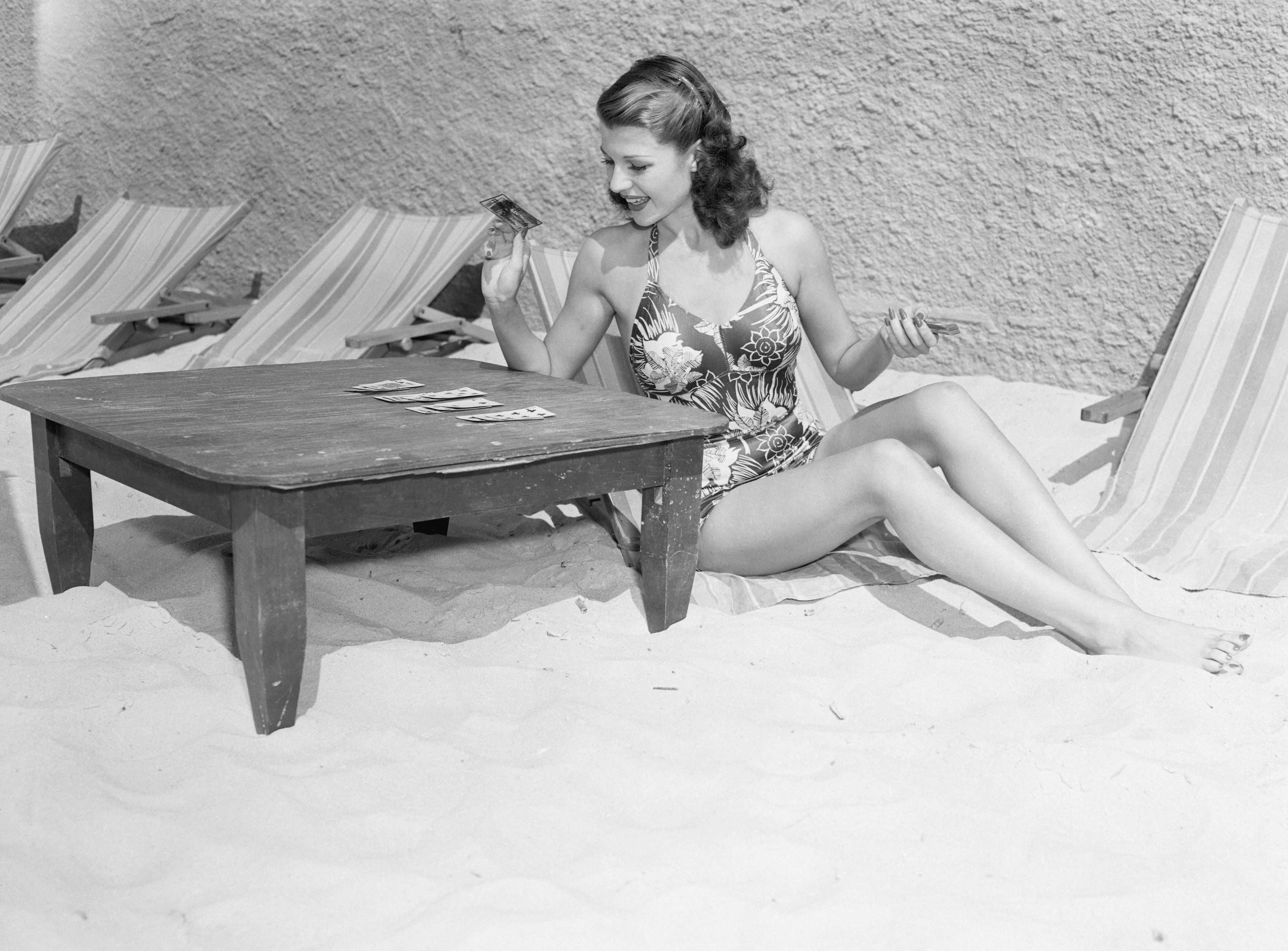 Rita Hayworth Playing Cards at a Beach