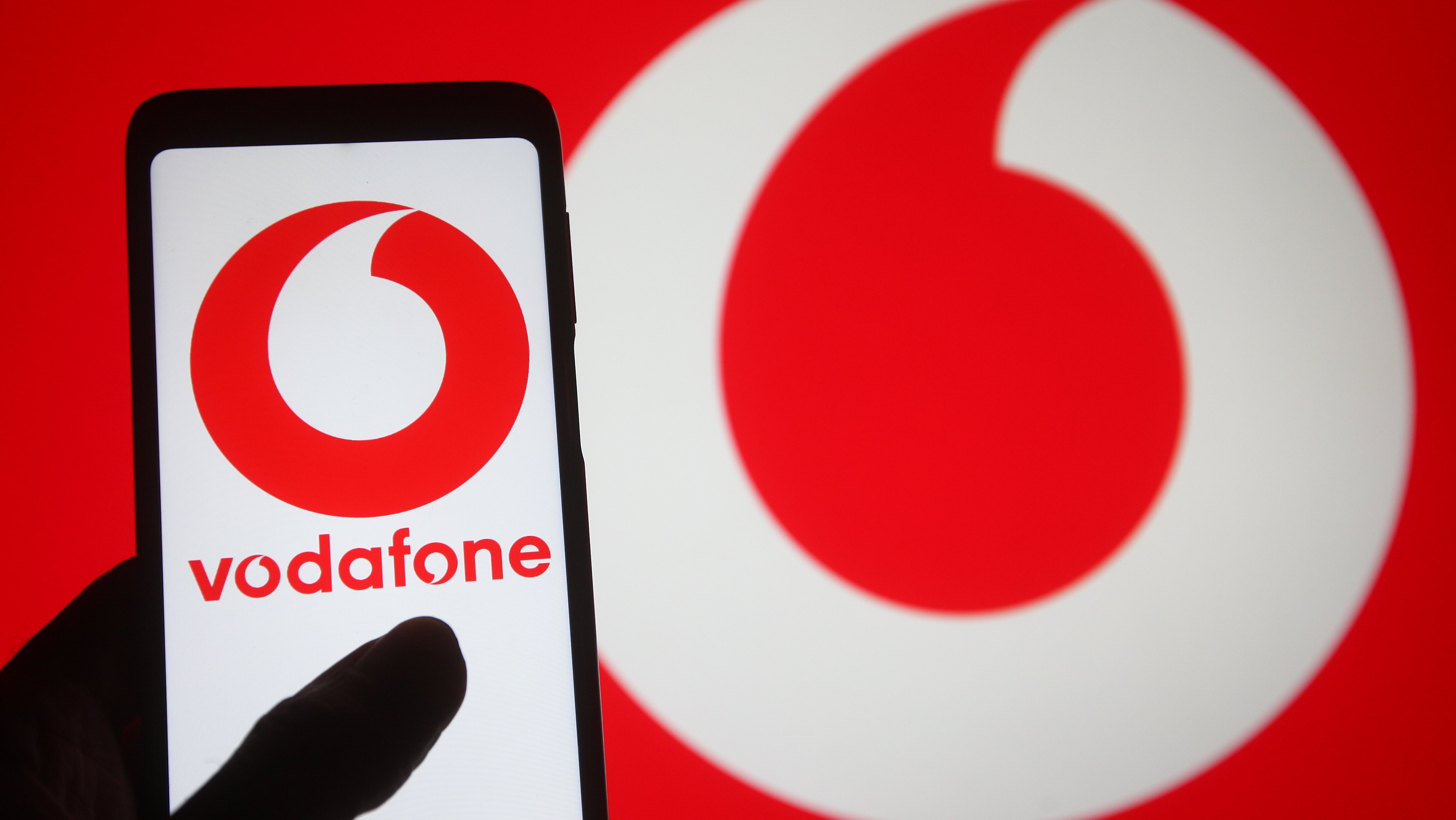 In this photo illustration, the Vodafone logo of a