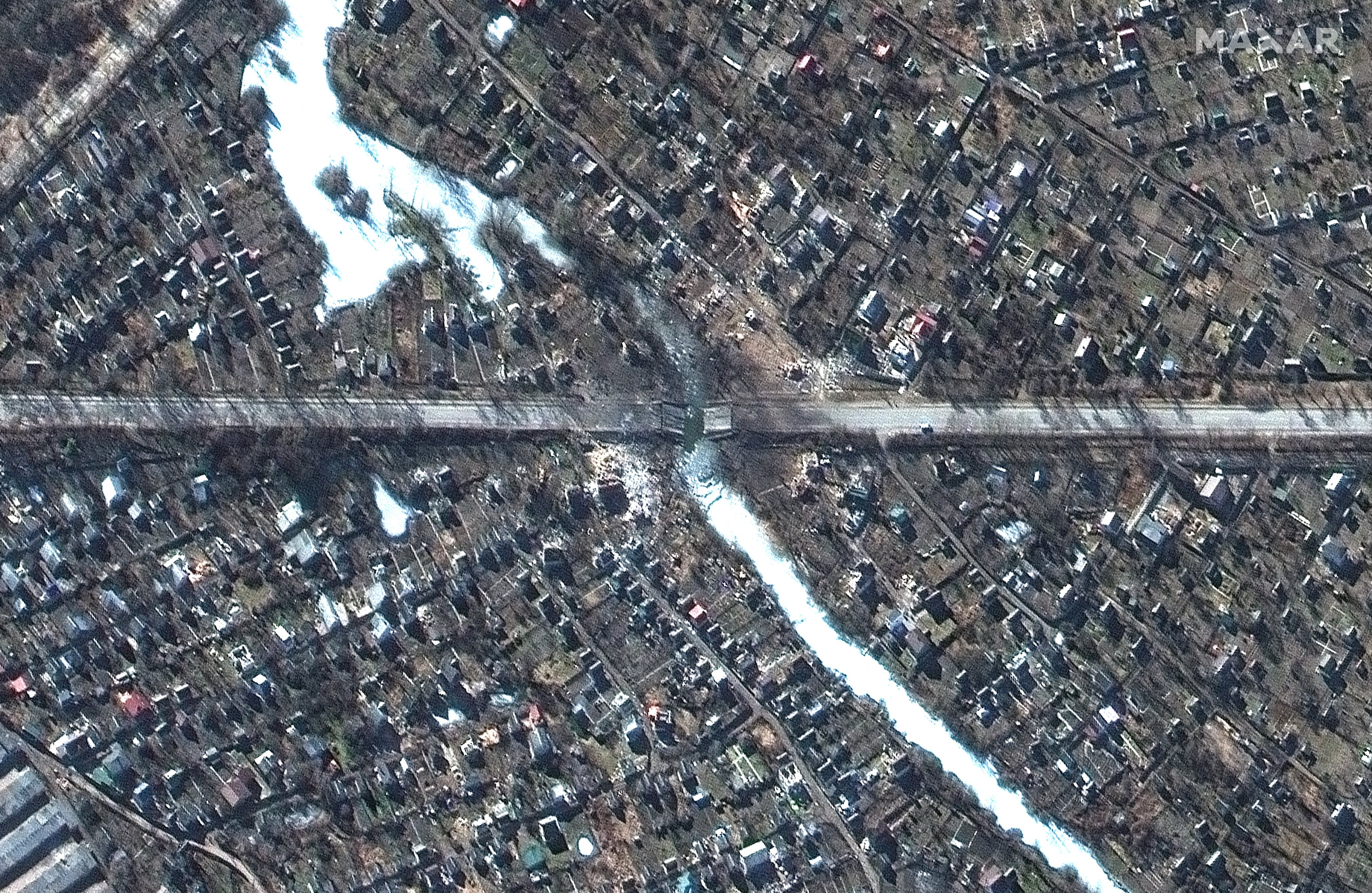 RUSSIANS INVADE UKRAINE -- FEBRUARY 28, 2022:  02 Maxar satellite imagery of a destroyed bridge and homes in Chernihiv, Ukraine.  28feb2022_wv2.  Please use: Satellite image (c) 2022 Maxar Technologies.