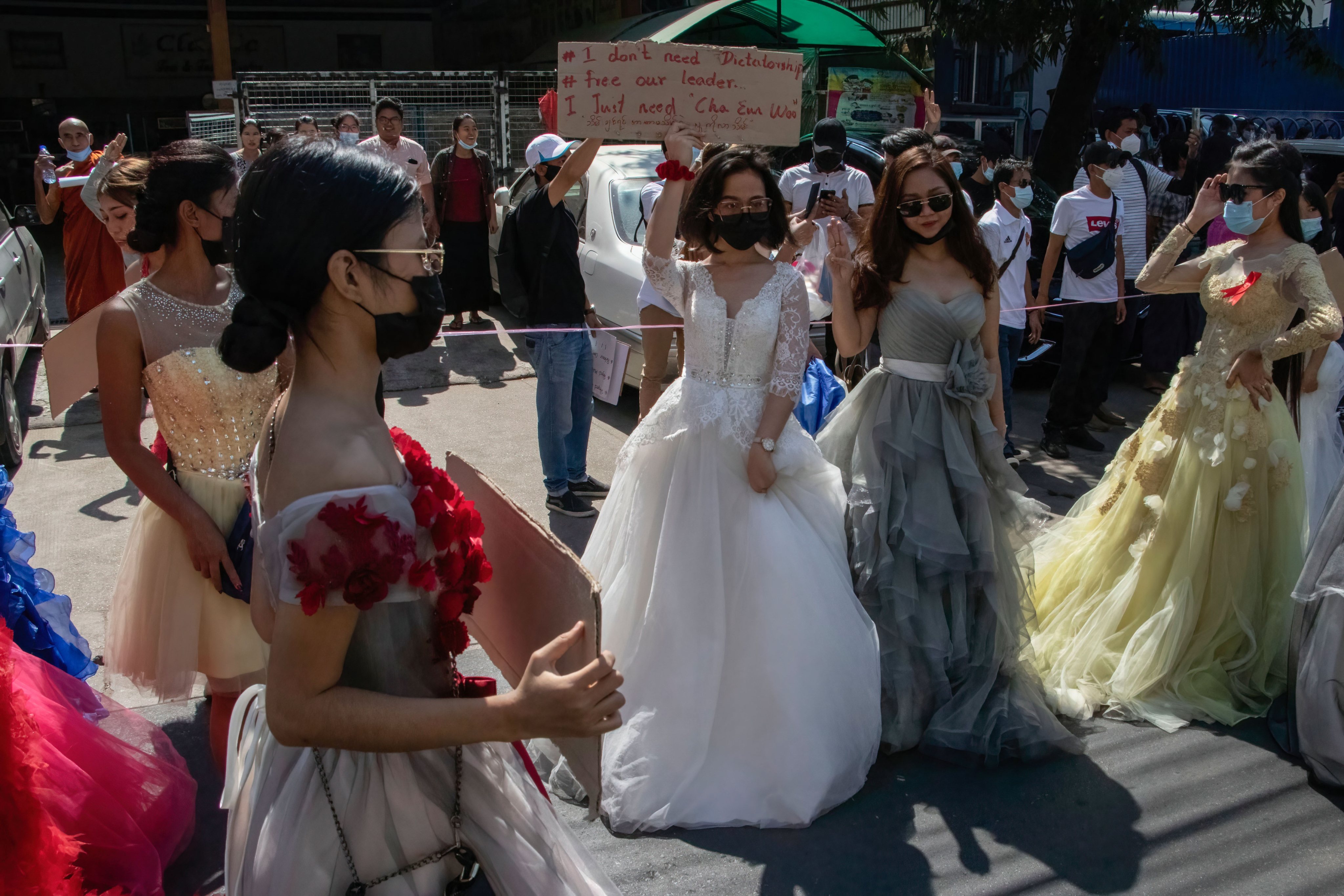 Protesters wearing wedding gowns march on the streets