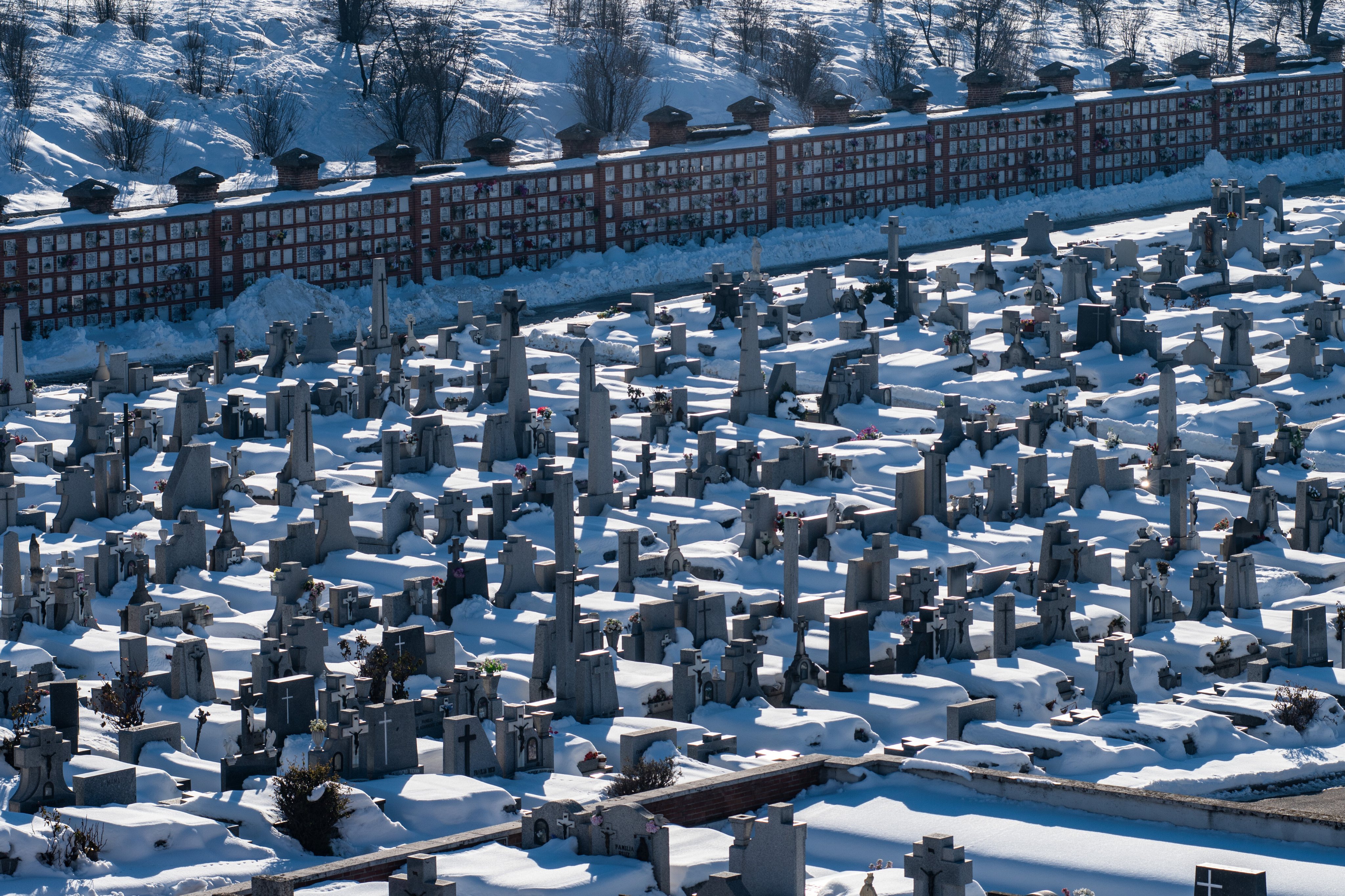 Graves in La Almudena Cemetery covered with snow one week