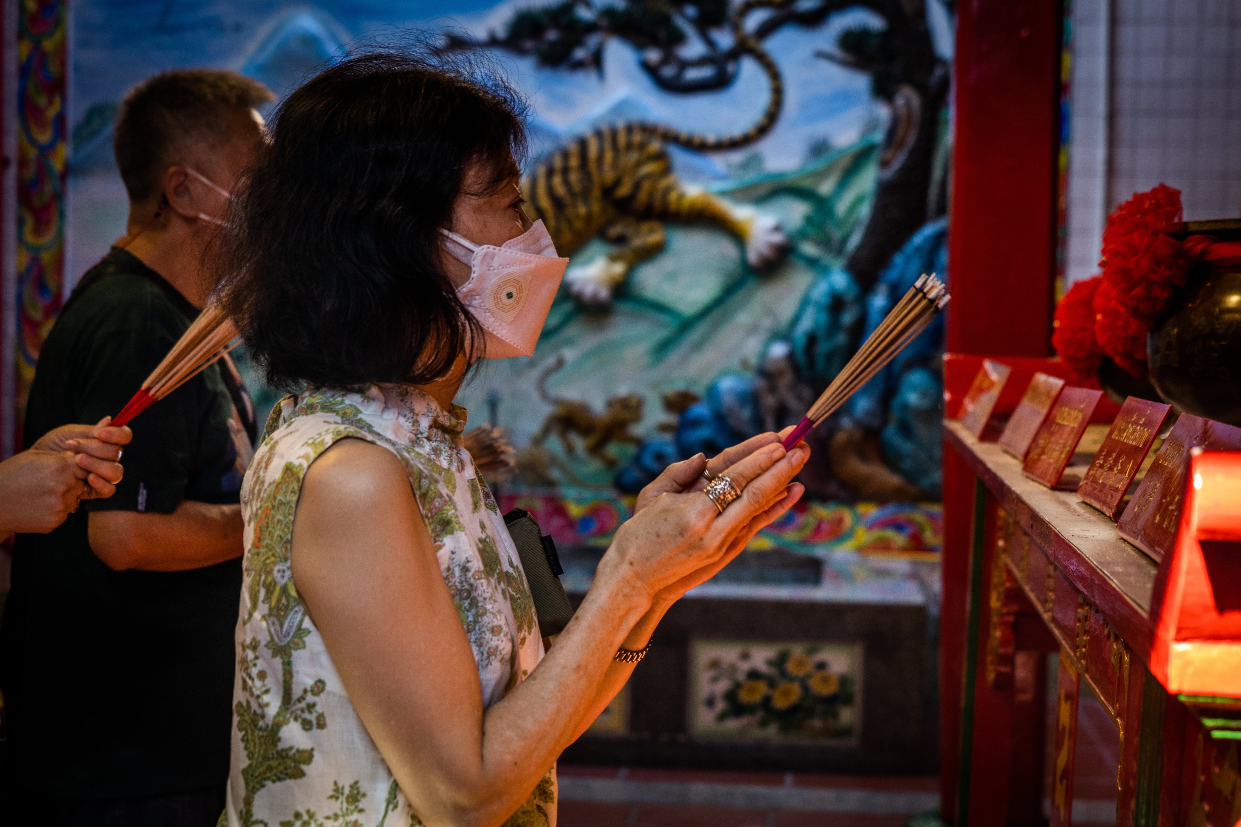 A woman prays at a temple in Bangkok&#039;s Chinatown on the