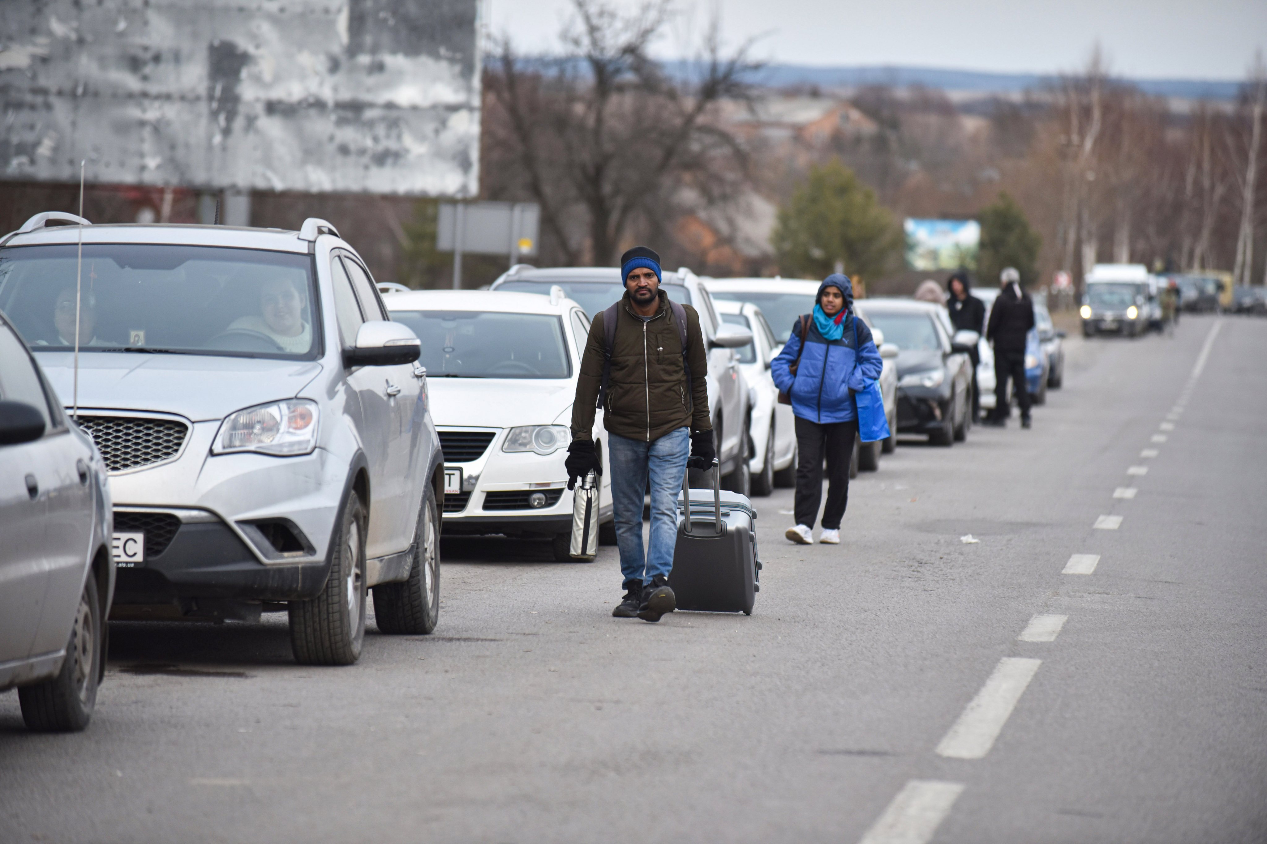 Foreigners walk to Shehyni checkpoint to cross Ukrainian-