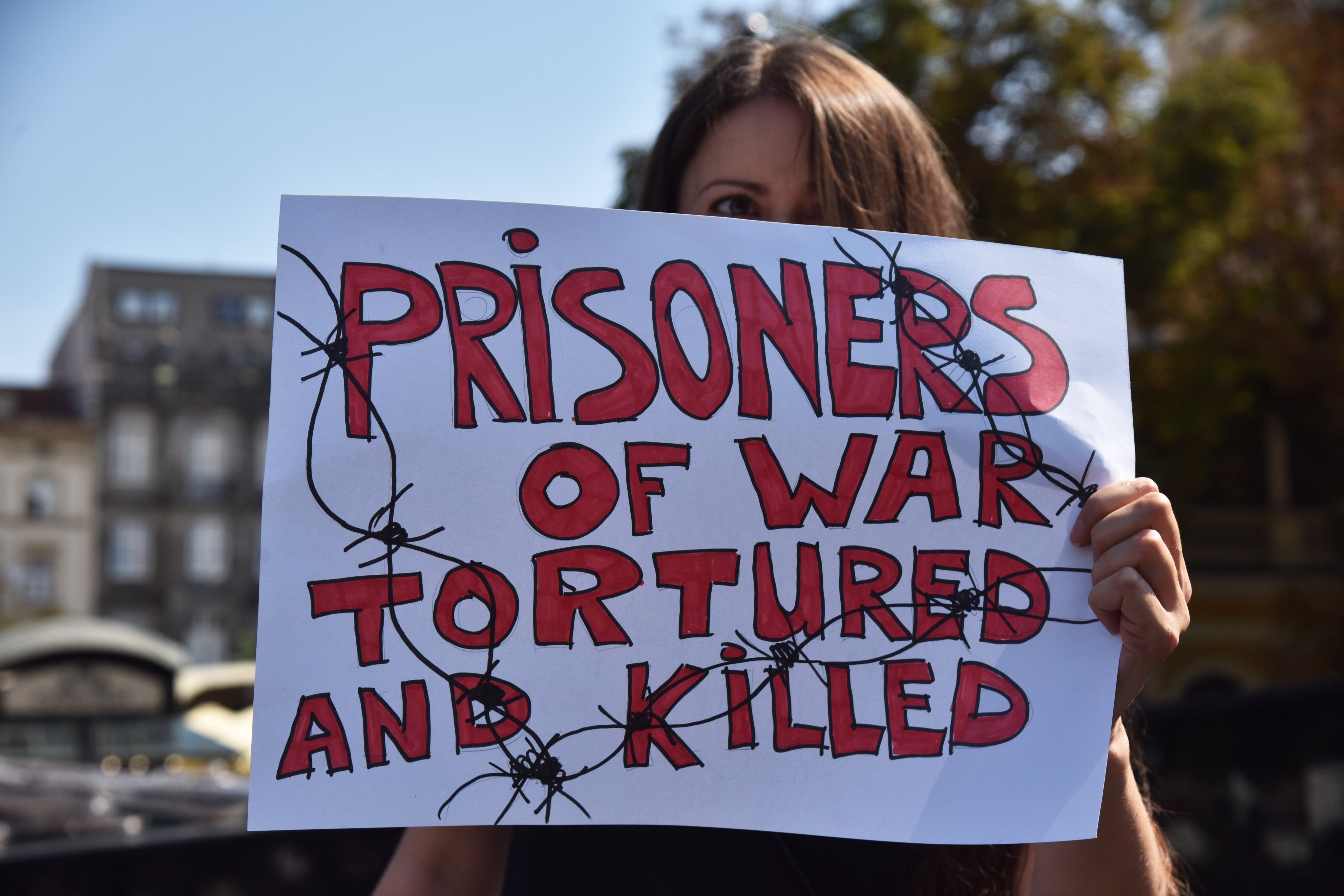A protester holds a placard calling for the release of