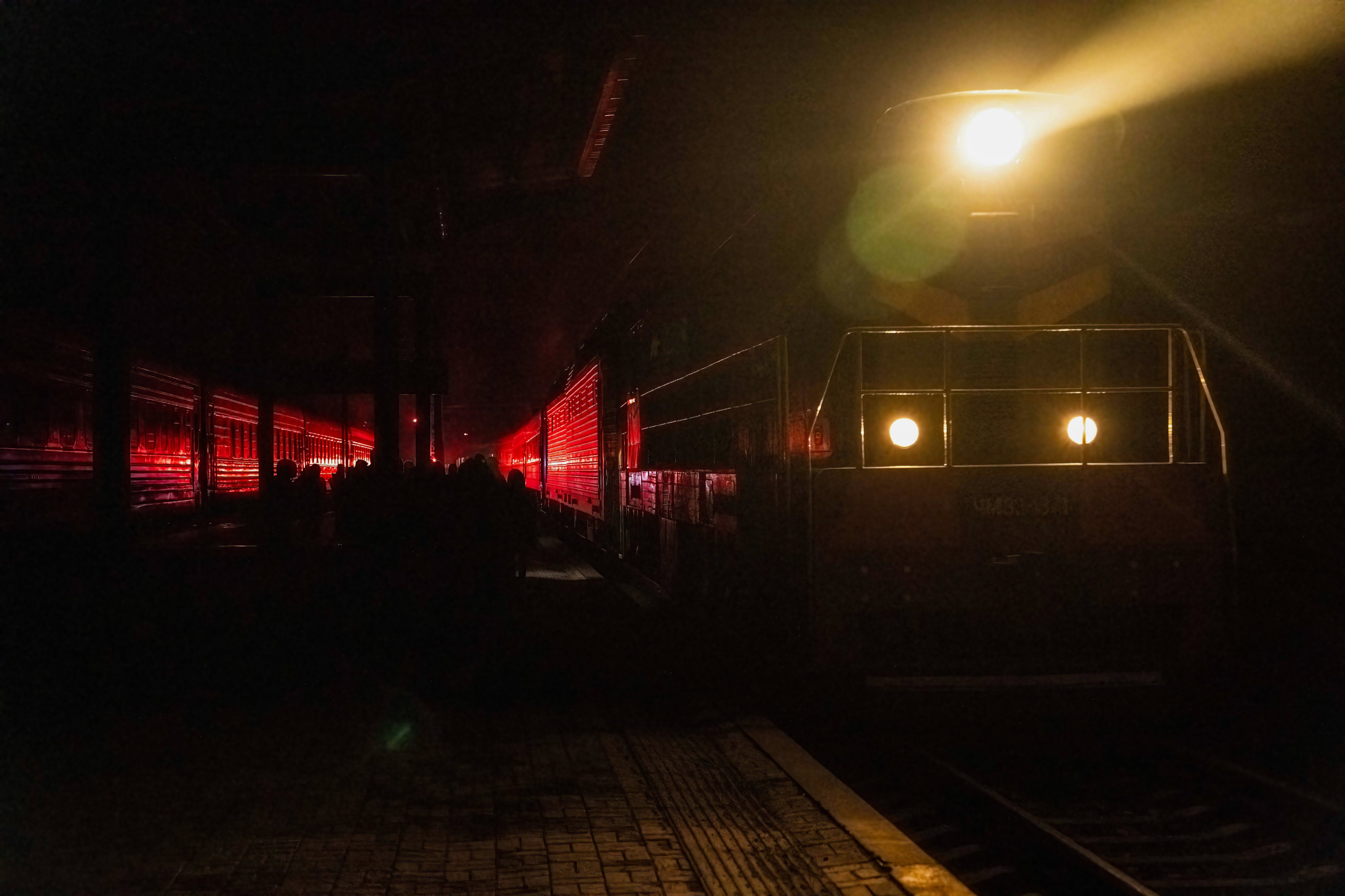 A delayed train arrives in a dark train station in Dnipro